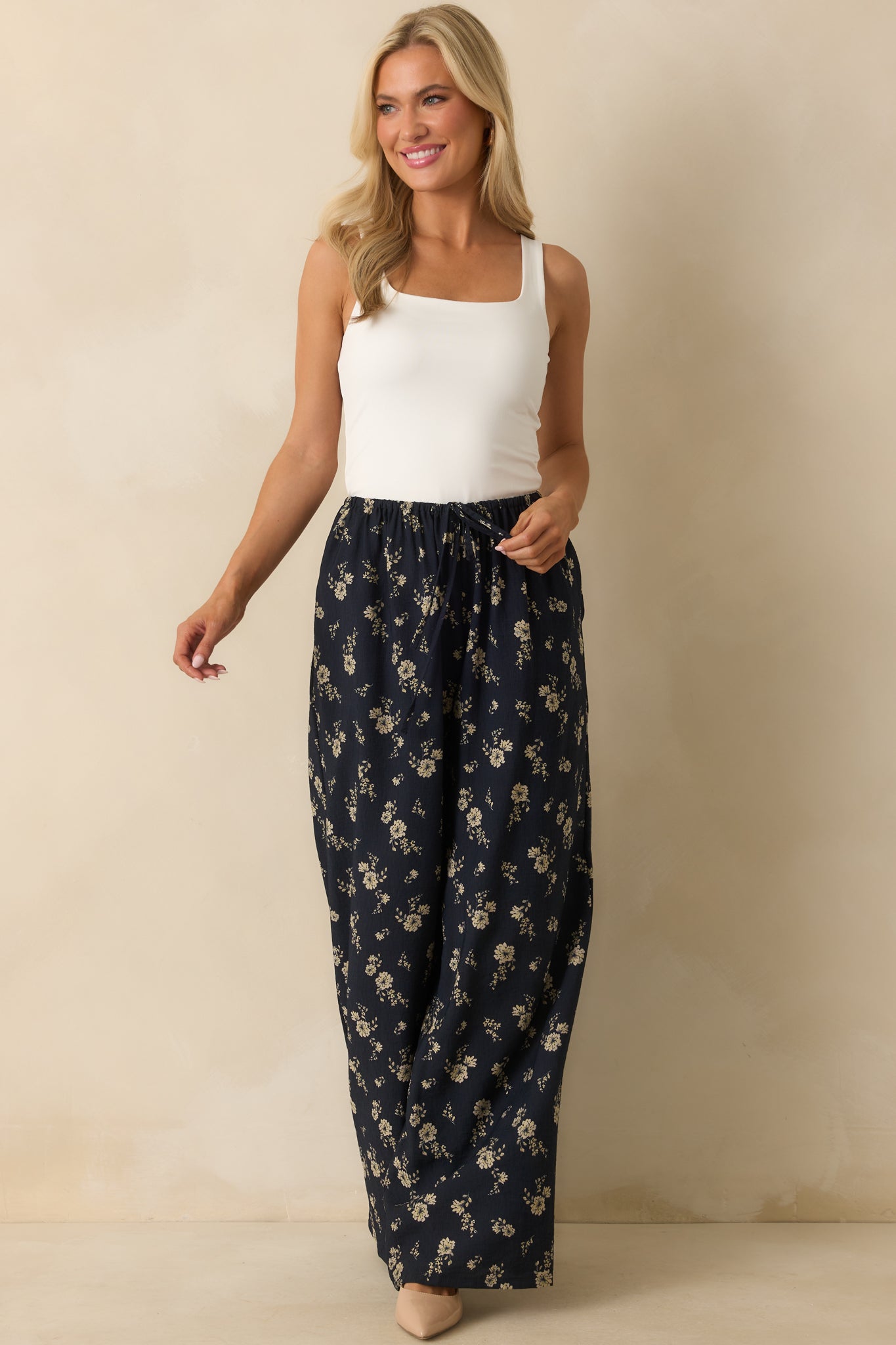 Full body image of the navy floral pants, showing the wide-leg cut and functional side seam pockets.