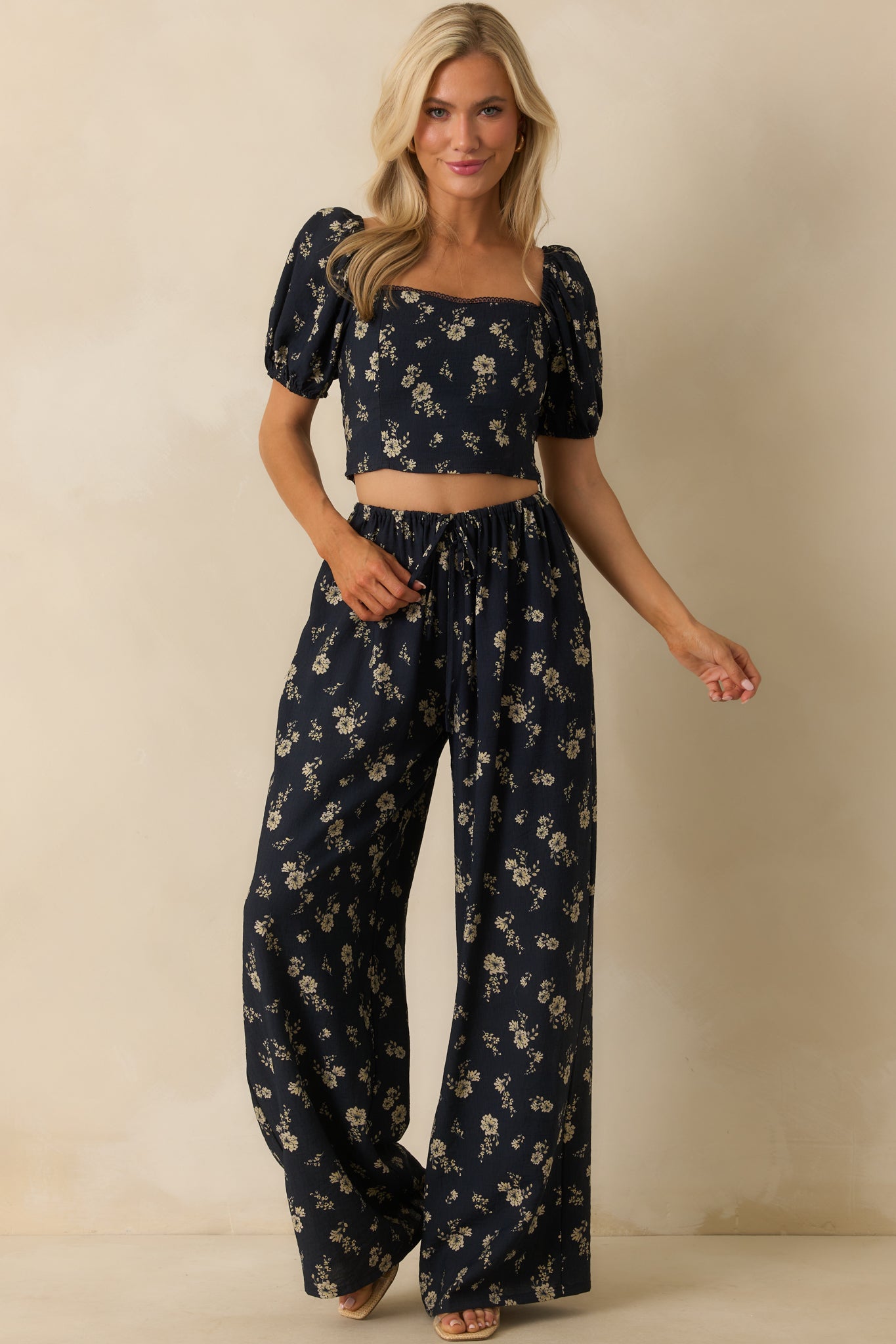Full body image of the navy floral top, showing the front paneling seams and fitted silhouette.