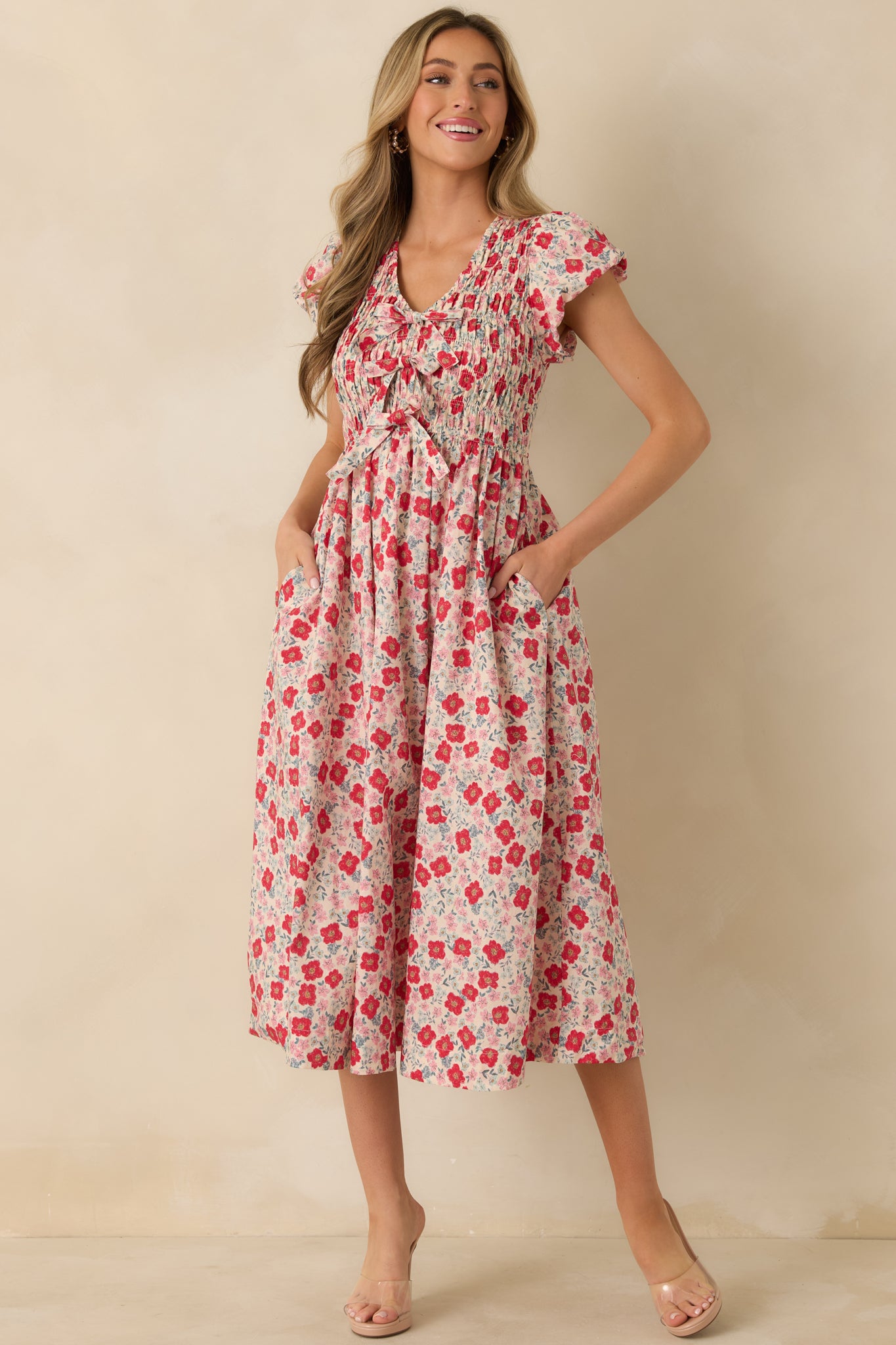 Front-facing full body photo highlighting the V-neckline, bow accents, and relaxed gathered silhouette.