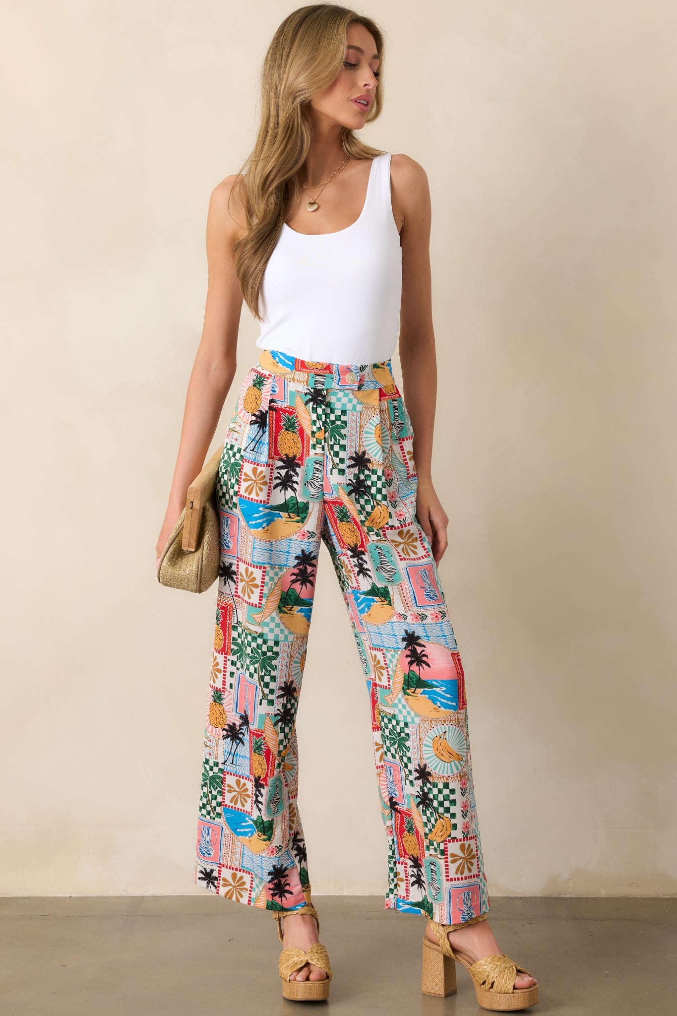 Angled full body shot of tropical pants showcasing the structured fit, beige button closure, and clean silhouette.