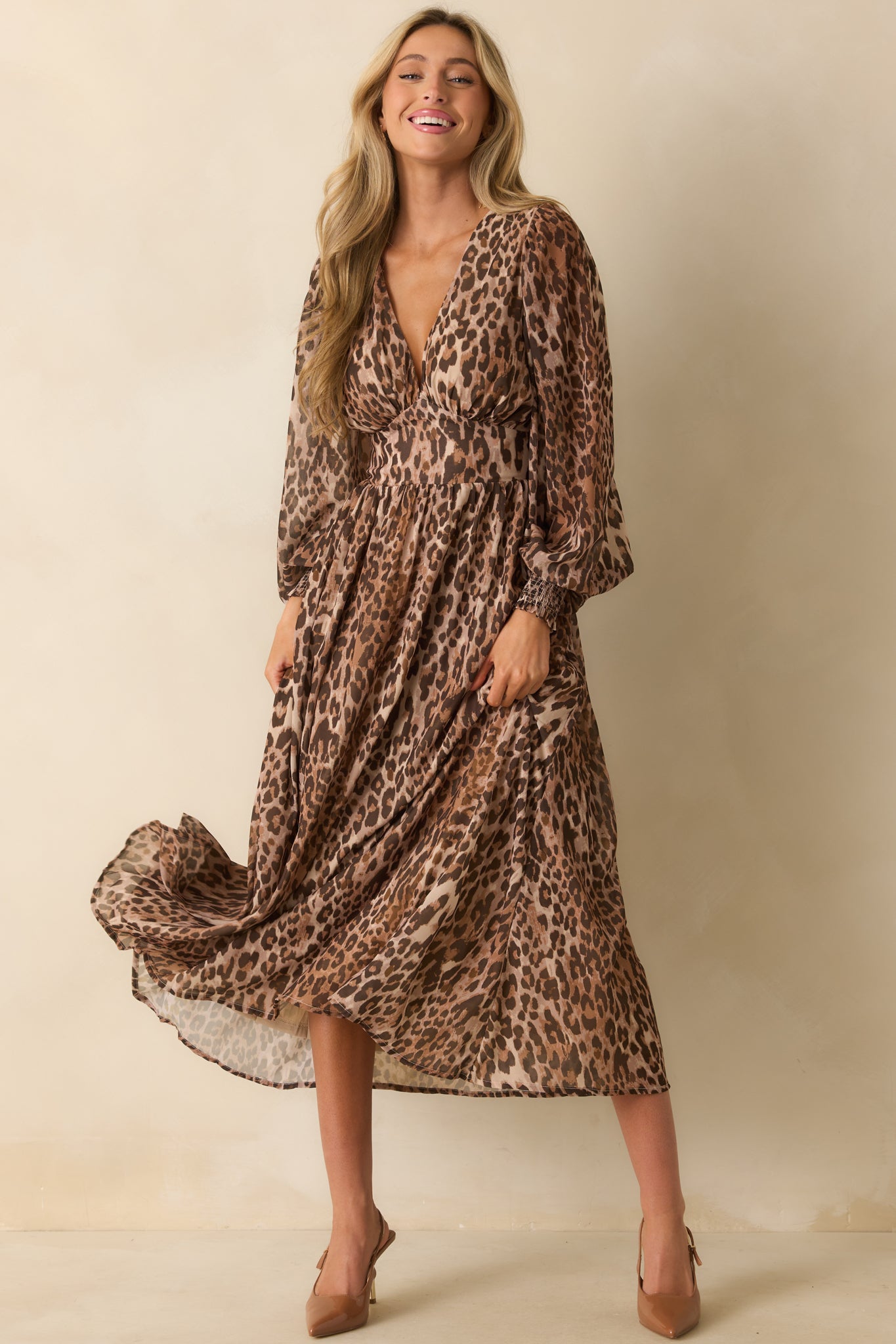 A full body shot showing the long balloon sleeves, deep v-neck, and flowy maxi silhouette.
