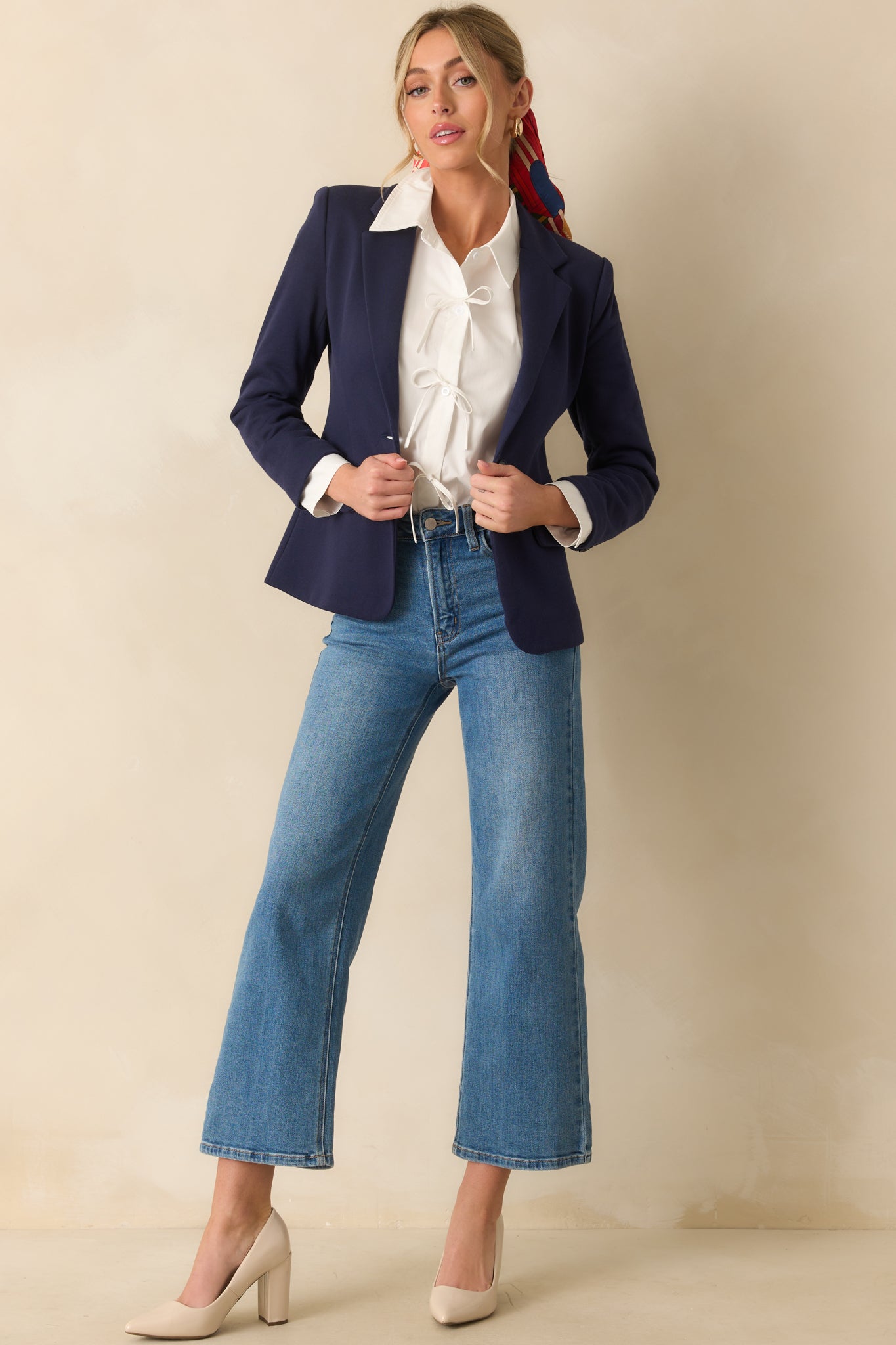 A full body shot highlighting the single functional button closure and tailored silhouette.