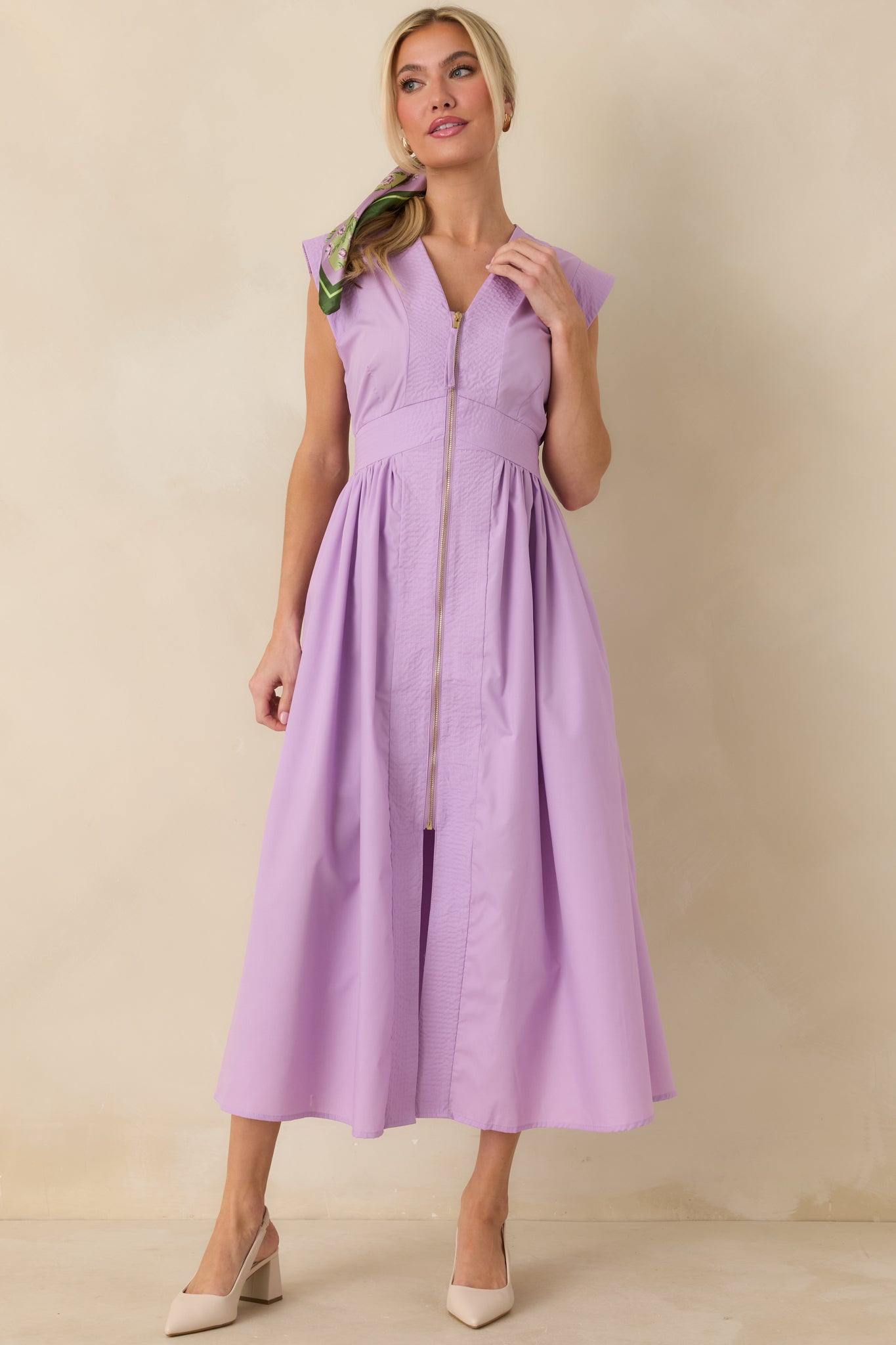 Straight-on full body view emphasizing the defined waist and gentle skirt gathering beneath the zip-front bodice.