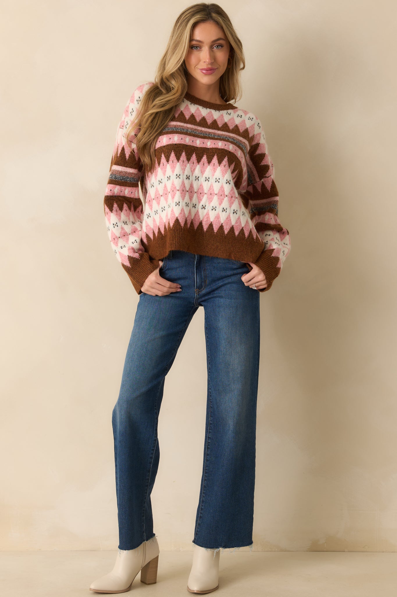 A full body view emphasizing the long sleeves with ribbed hems and patterned design across the chest.