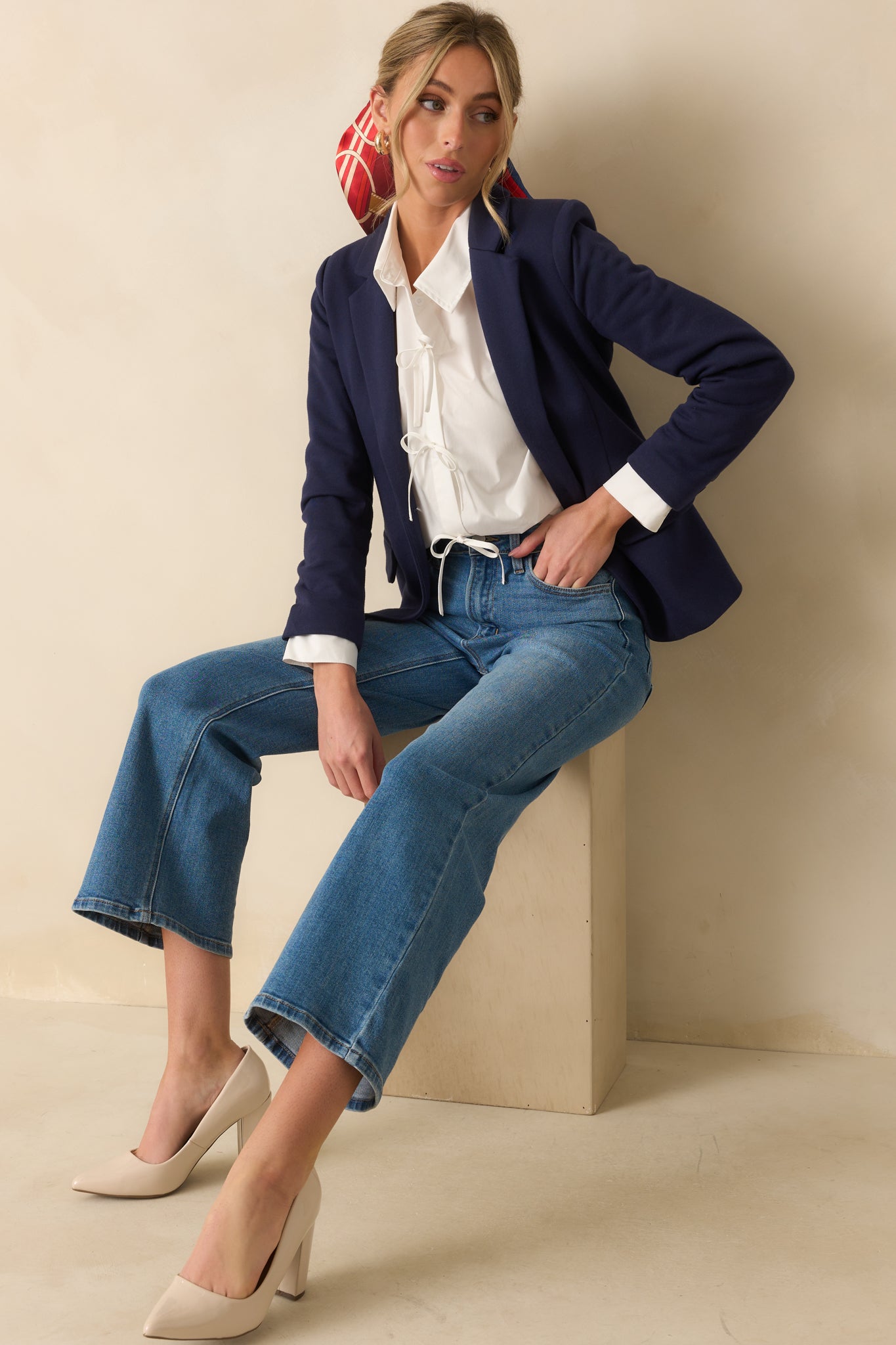 A full body view of the navy blue blazer featuring a notch lapel collar and structured fit.