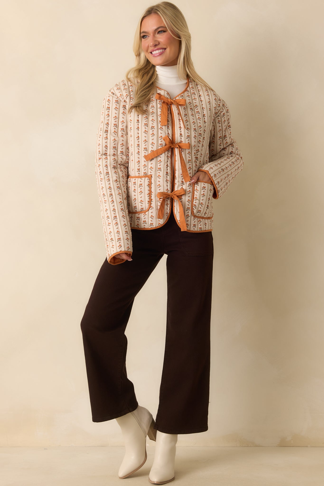 A full body shot highlighting the relaxed fit and functional patch pockets on the front of the floral jacket.