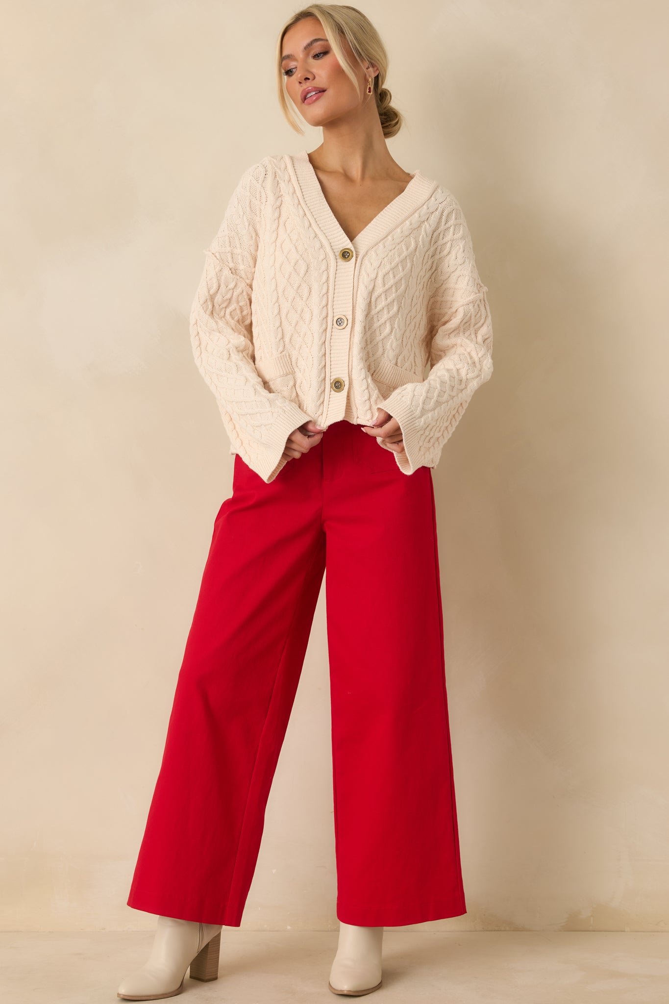 Full-body front view of the ivory cardigan focusing on the v-neckline and button-front detail.