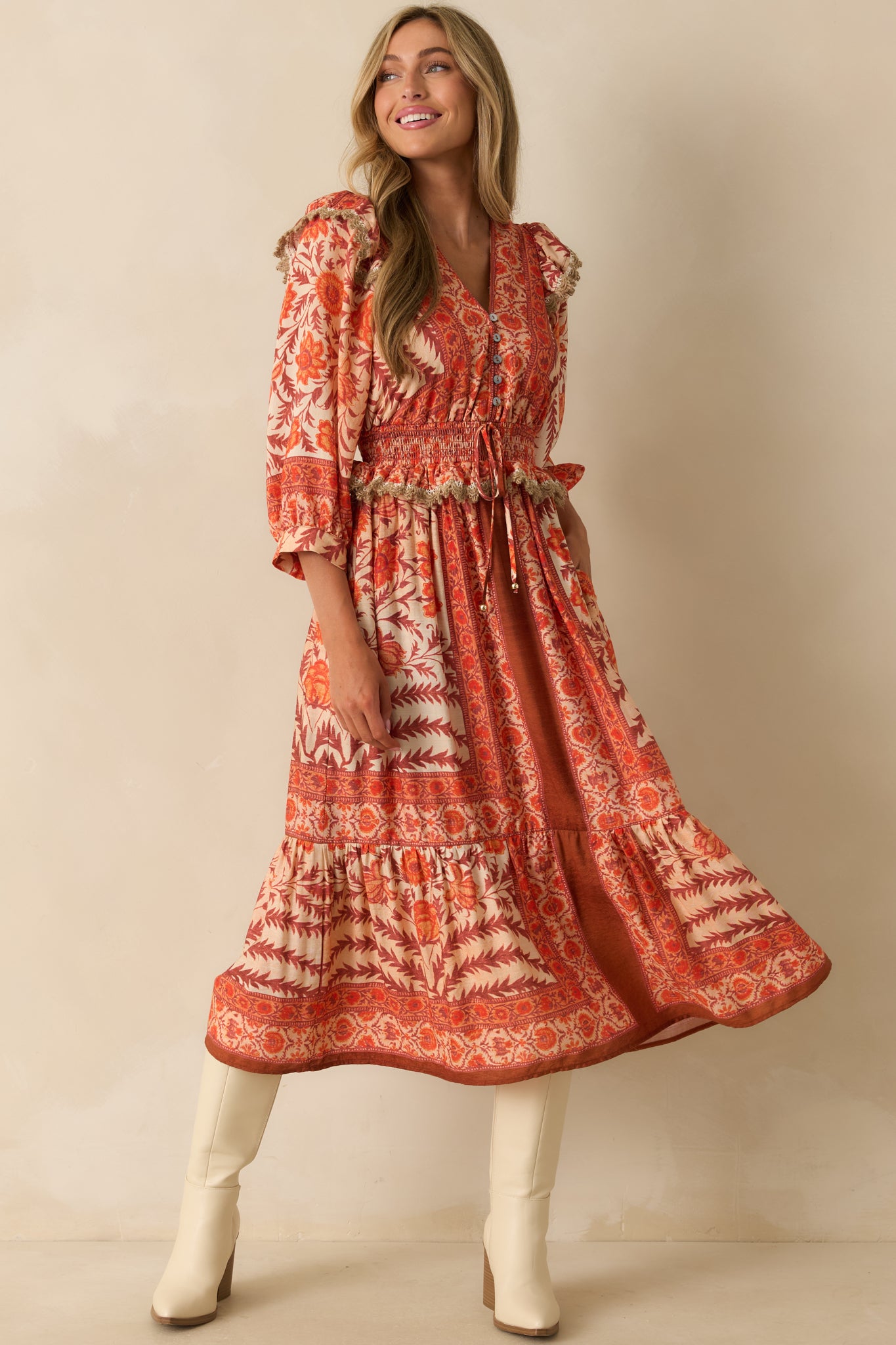 Full body front view of the orange maxi dress showcasing its multicolor patchwork floral print and v-neckline.