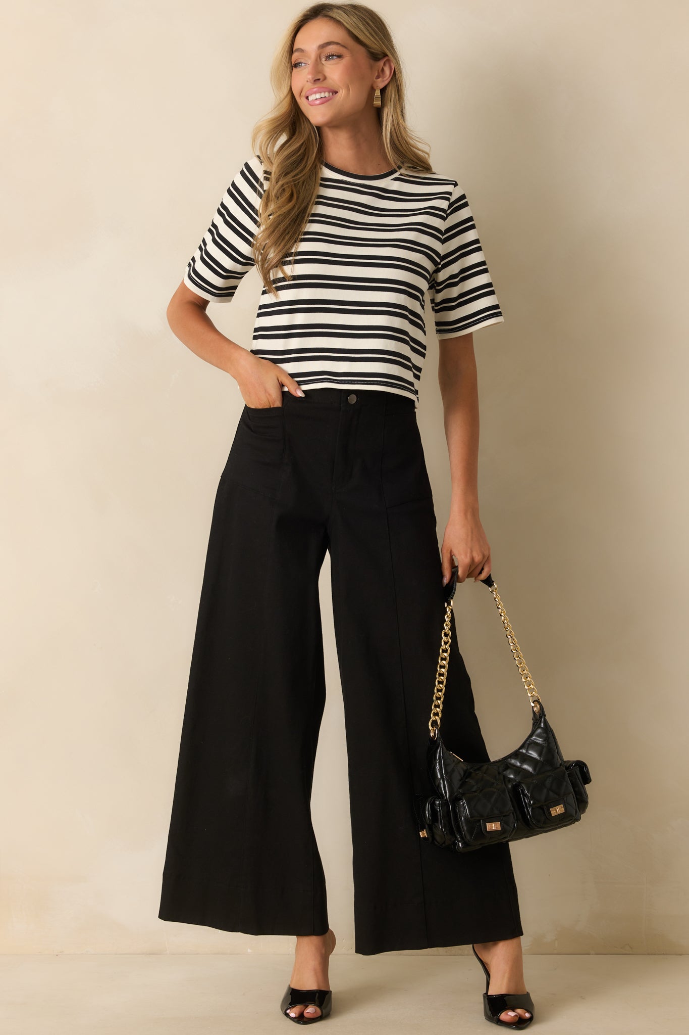 A full front view of the black high-waisted pants with a wide leg silhouette.