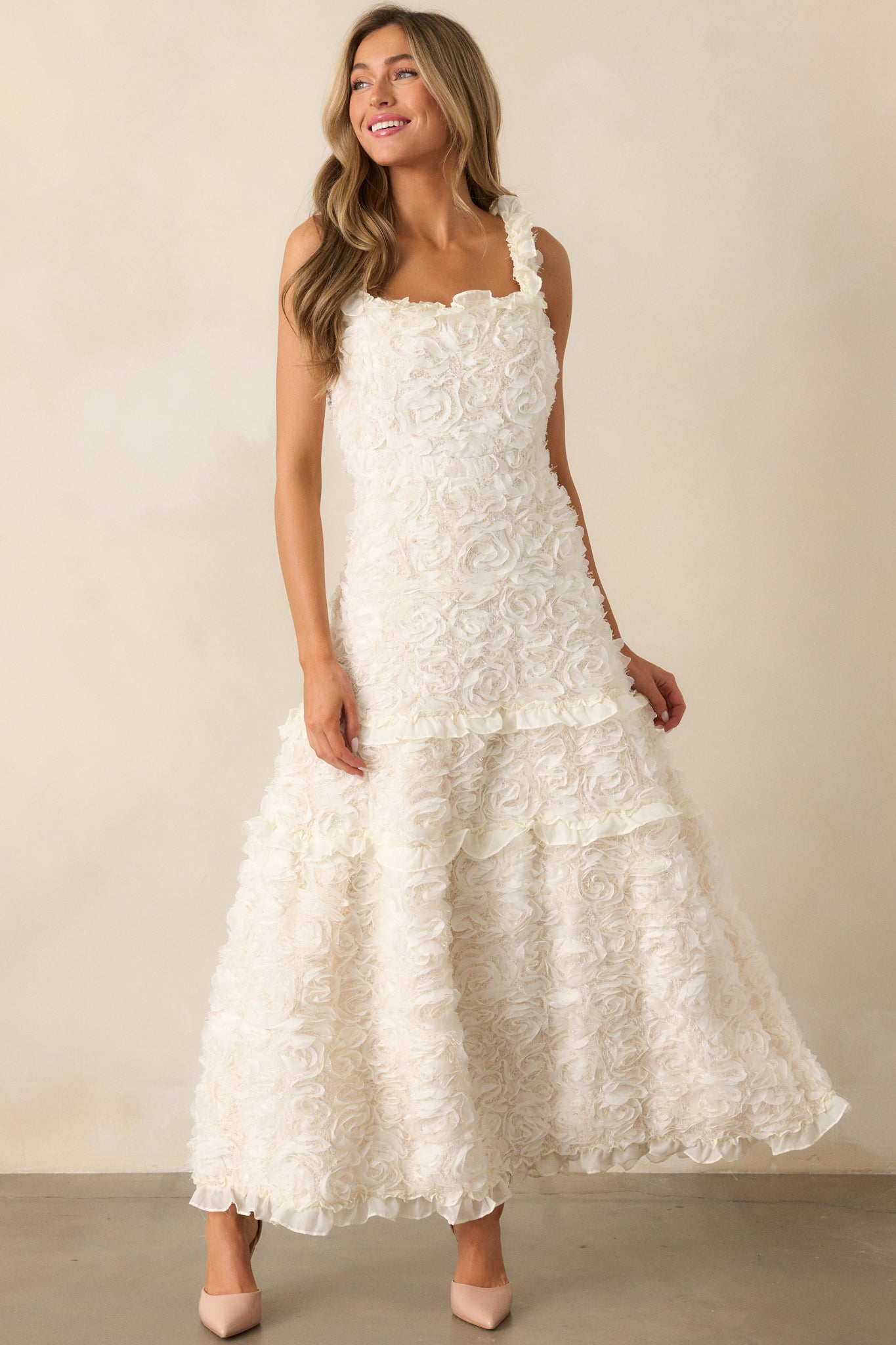 A complete look showcasing the ivory dress from a front angle, highlighting the ruffle shoulder details and the intricate floral appliques throughout.