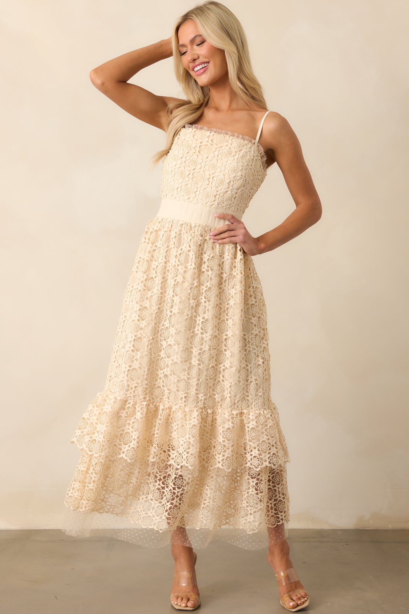 A full length image of the midi dress emphasizing the delicate embroidery and lace polka dot ruffle trim along the hem.