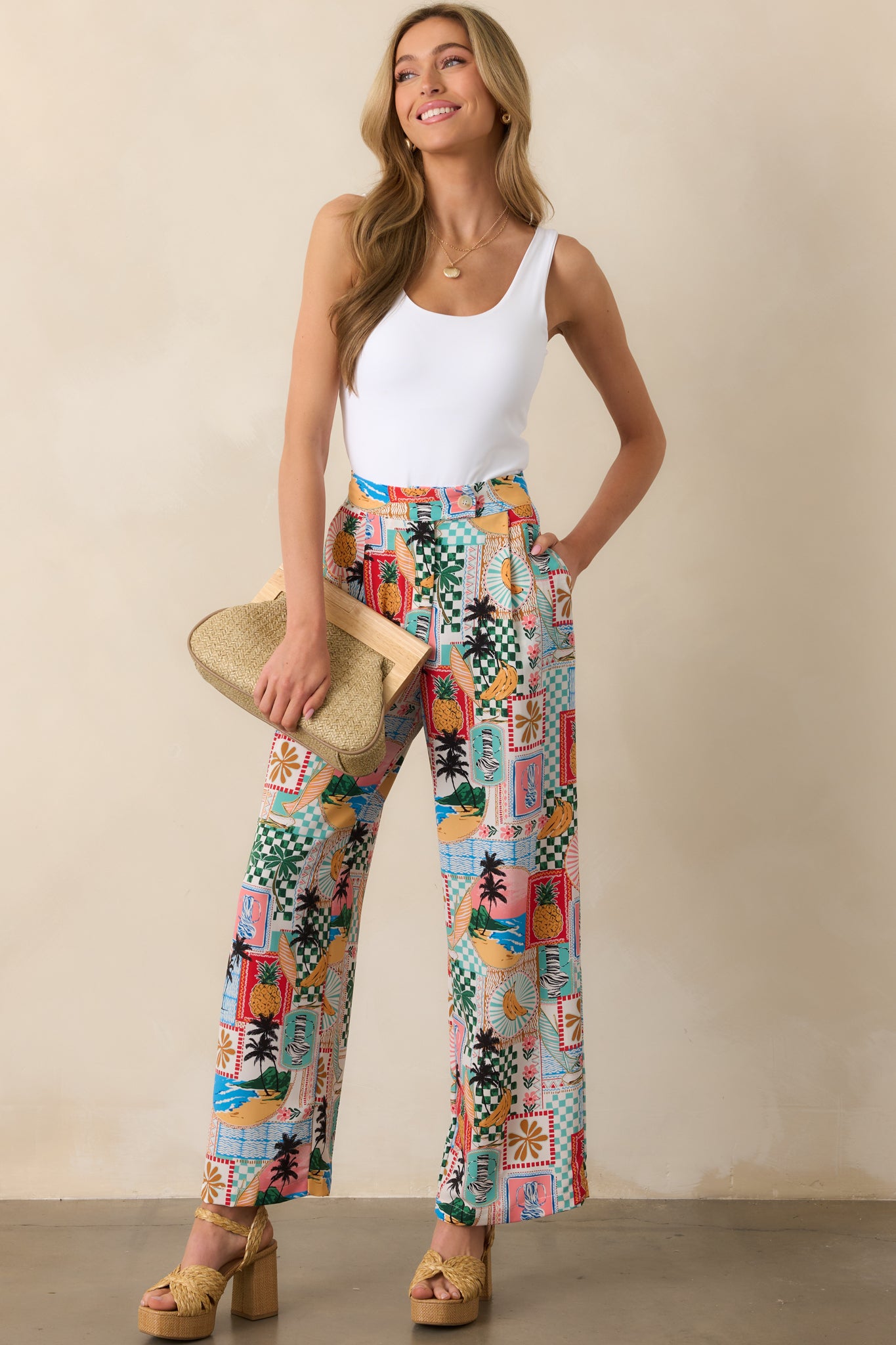 Full body image highlighting the high waist and straight leg cut of the tropical pants, styled with a smooth front panel.