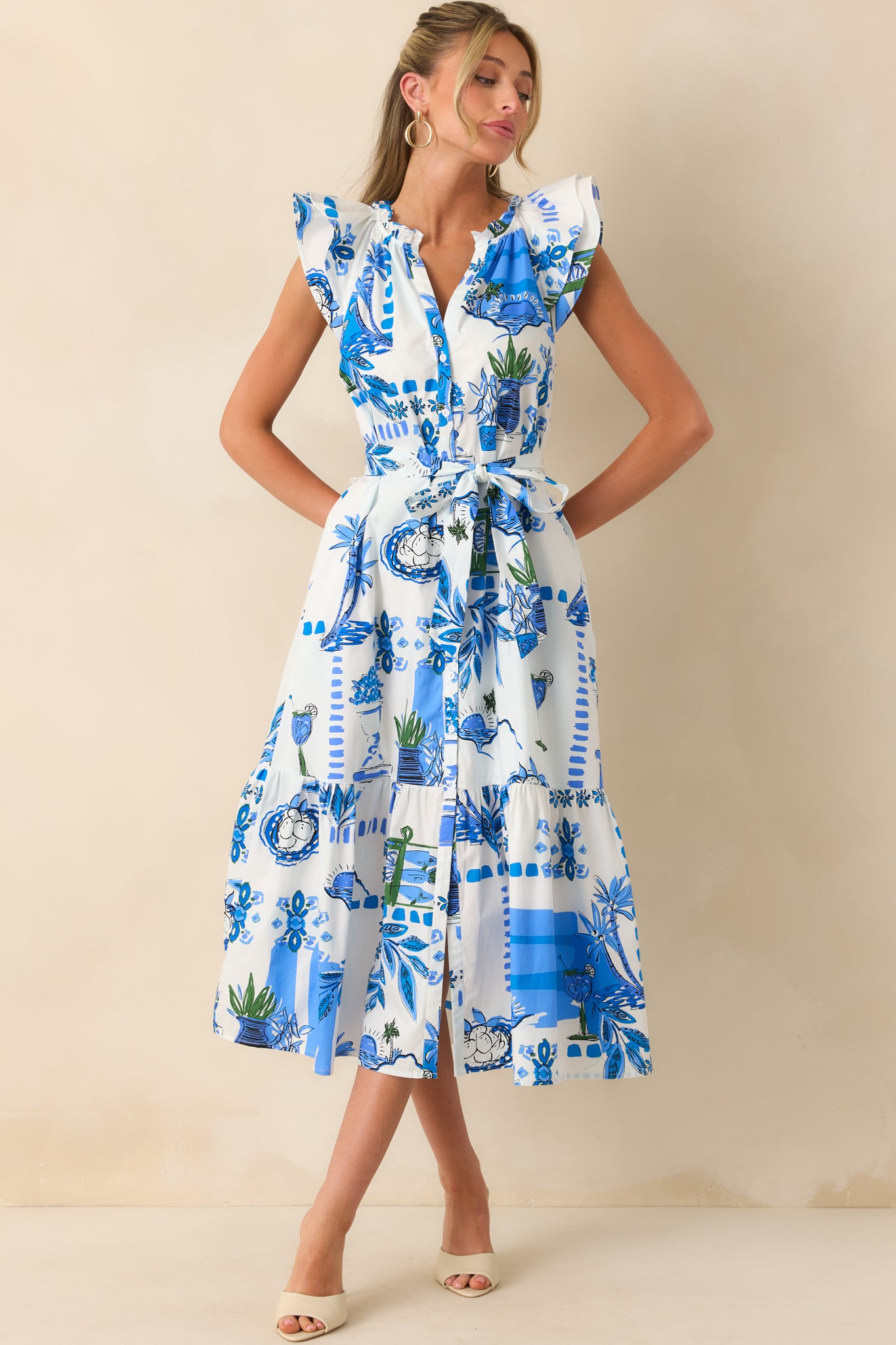 Full body image showcasing the layered flutter sleeves and the functional button front of the dress.