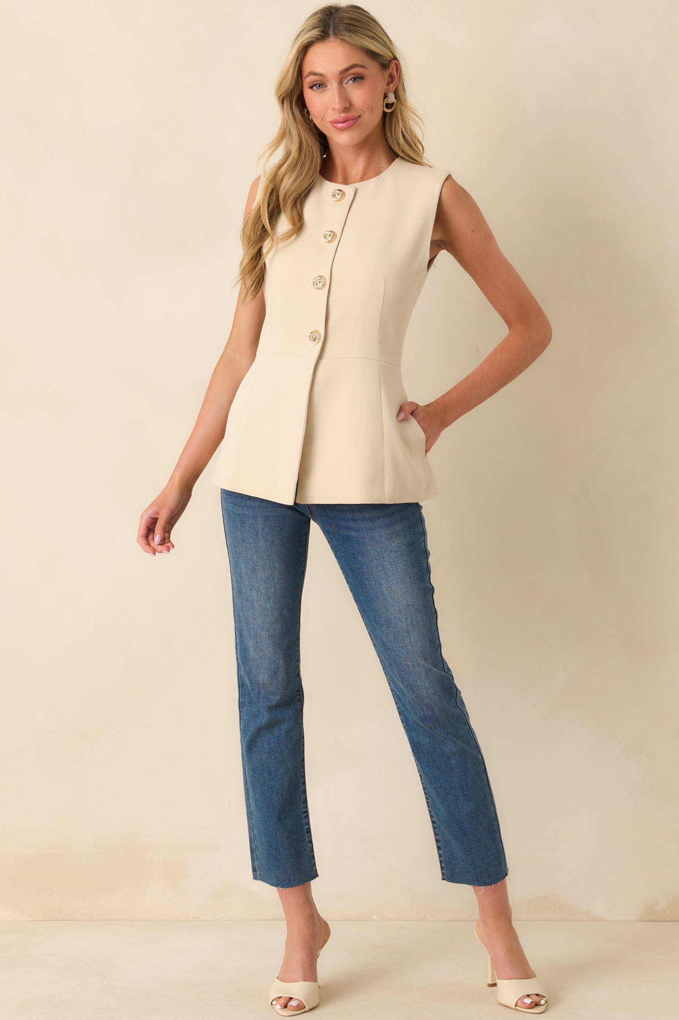 Full length image showing the sleeveless cut and slightly flared silhouette of the top.