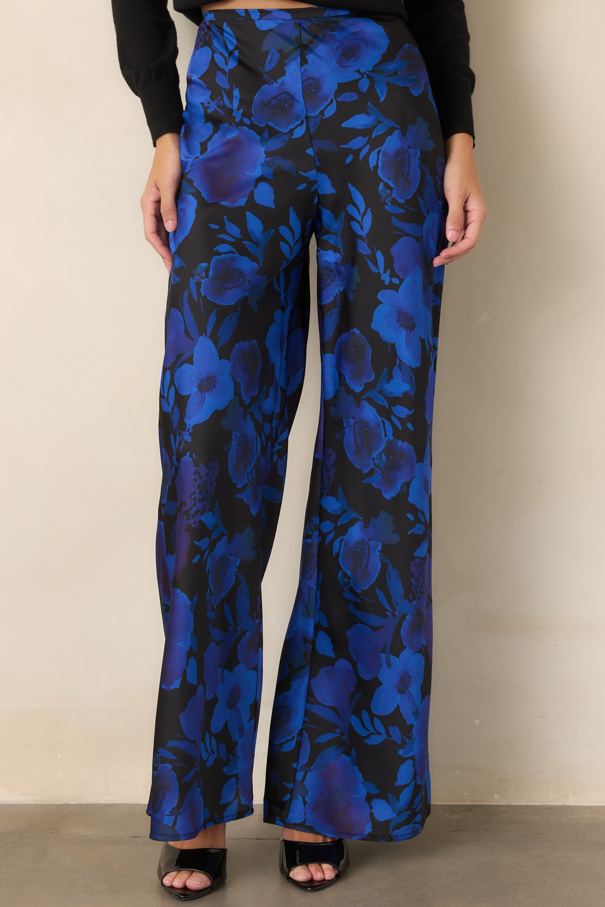 Full-length black pants with a flowing wide-leg shape and subtle polyester satin sheen.