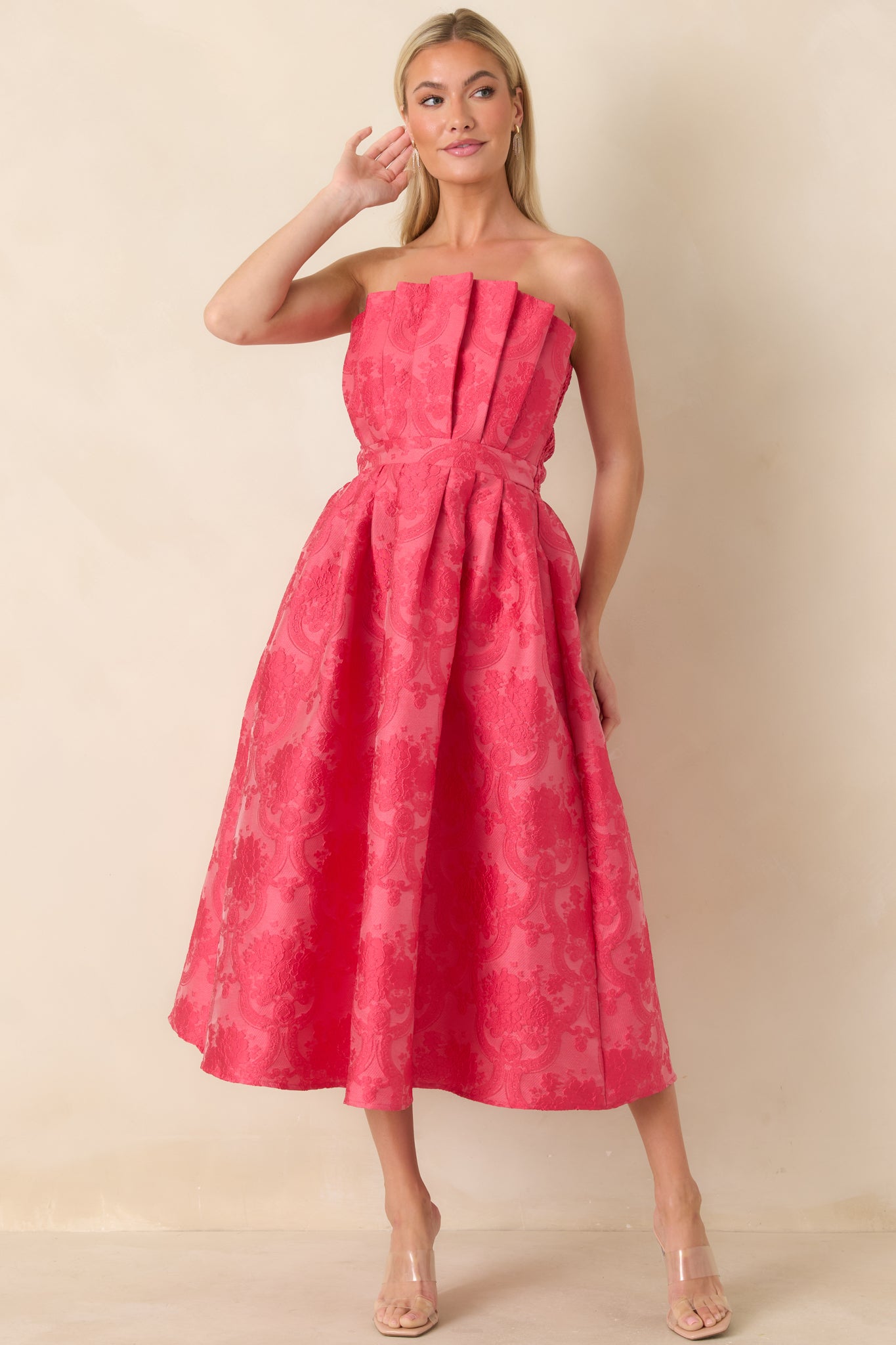Full-length front view of pink strapless dress showcasing subtle jacquard texture and flowing midi silhouette.