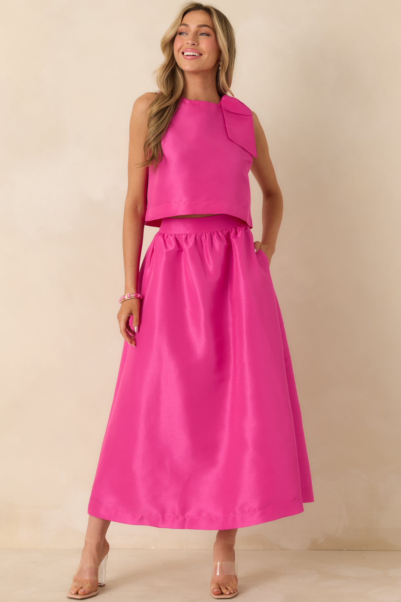 Full-length front view of the fuchsia pink maxi skirt featuring a high-rise waistband and flowing silhouette.