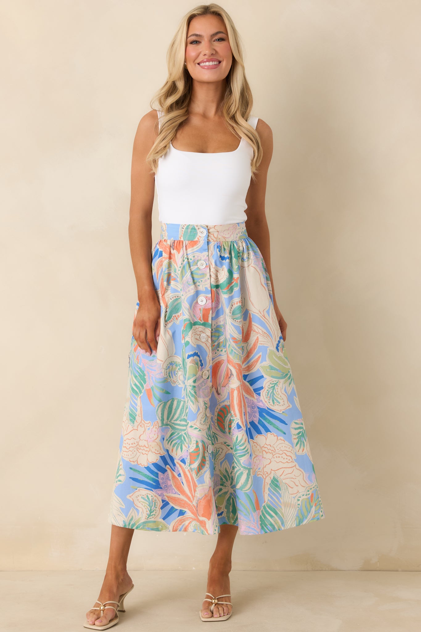 Full-length skirt with gathered fabric below structured waist and functional button-front closure for movement.