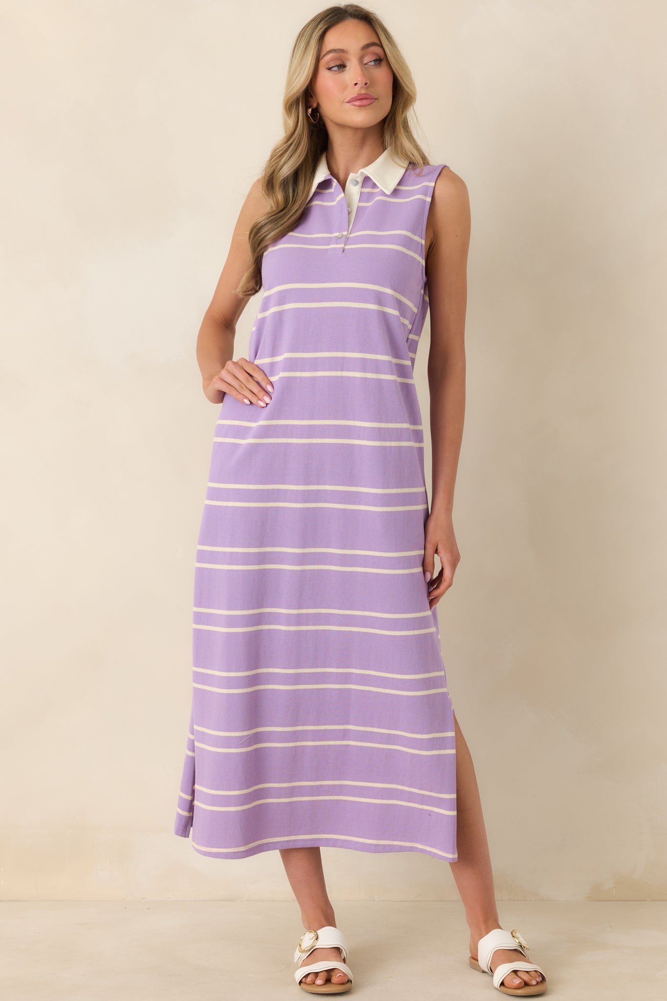 Full-length striped dress in soft lavender tones with a sleeveless cut and tailored collar detail.
