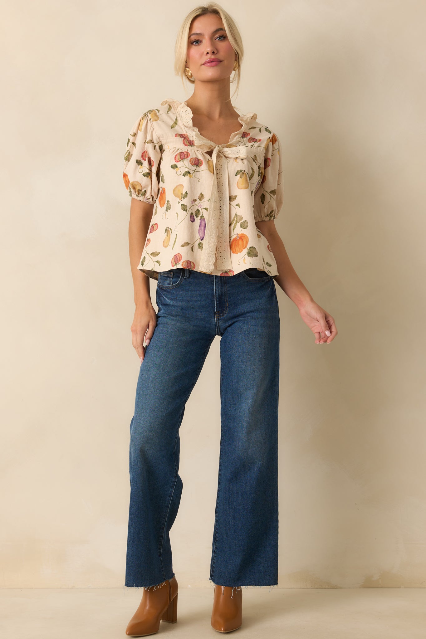 Full front look at ivory garden-print top with self-tie detail and elastic-cuffed sleeves.