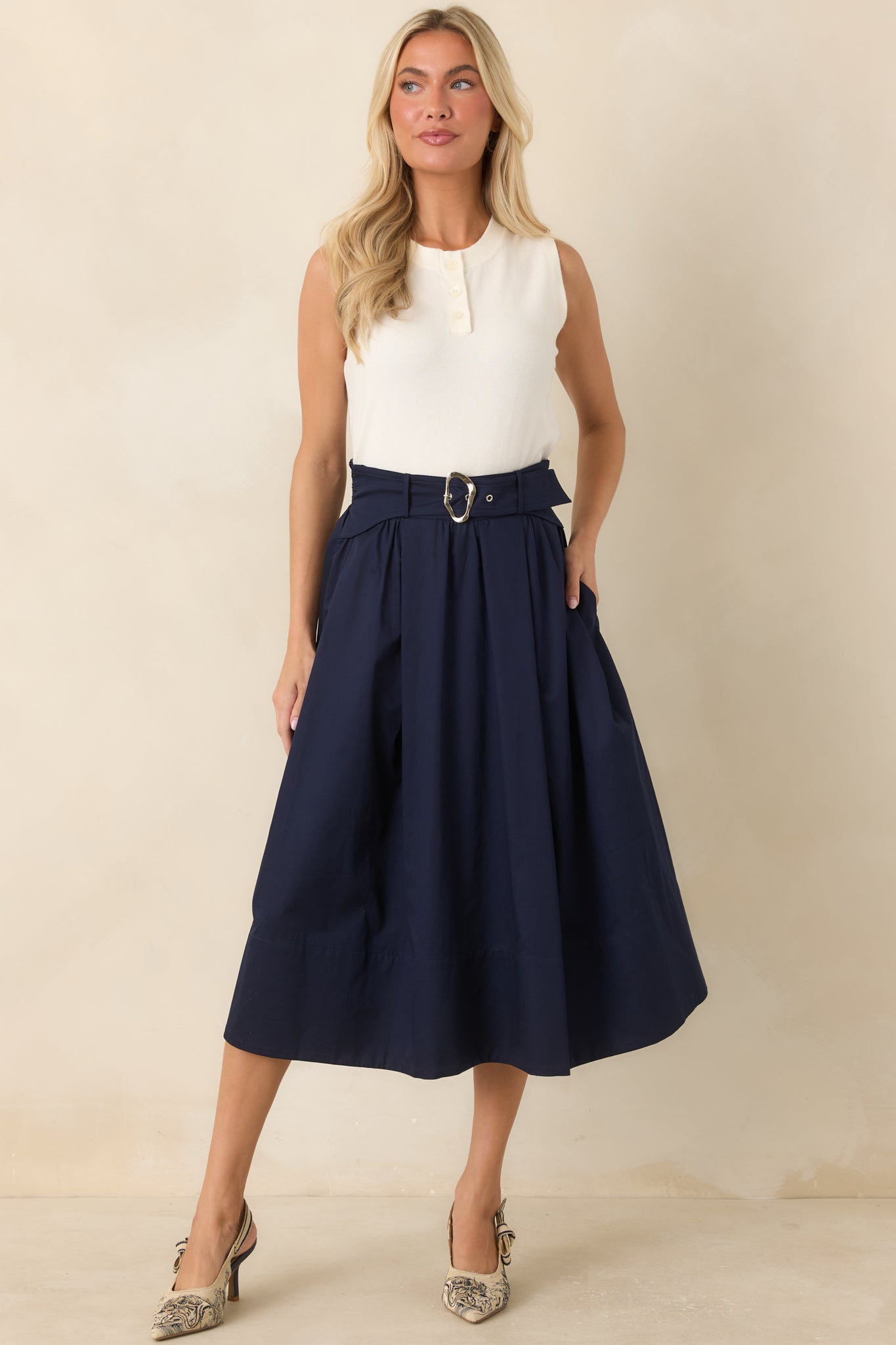 Full midi skirt crafted from crisp cotton with flowing pleats and a flattering belted waist detail