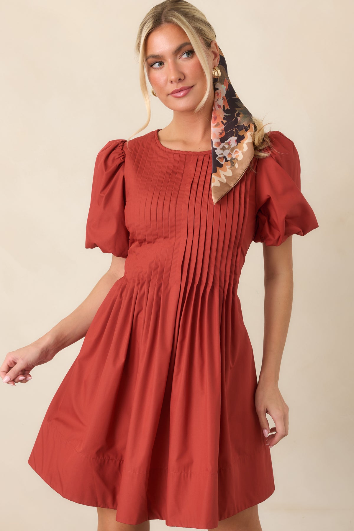 Full mini dress silhouette showcases softly gathered volume below the pintucked bodice and sculptural short puff sleeves.