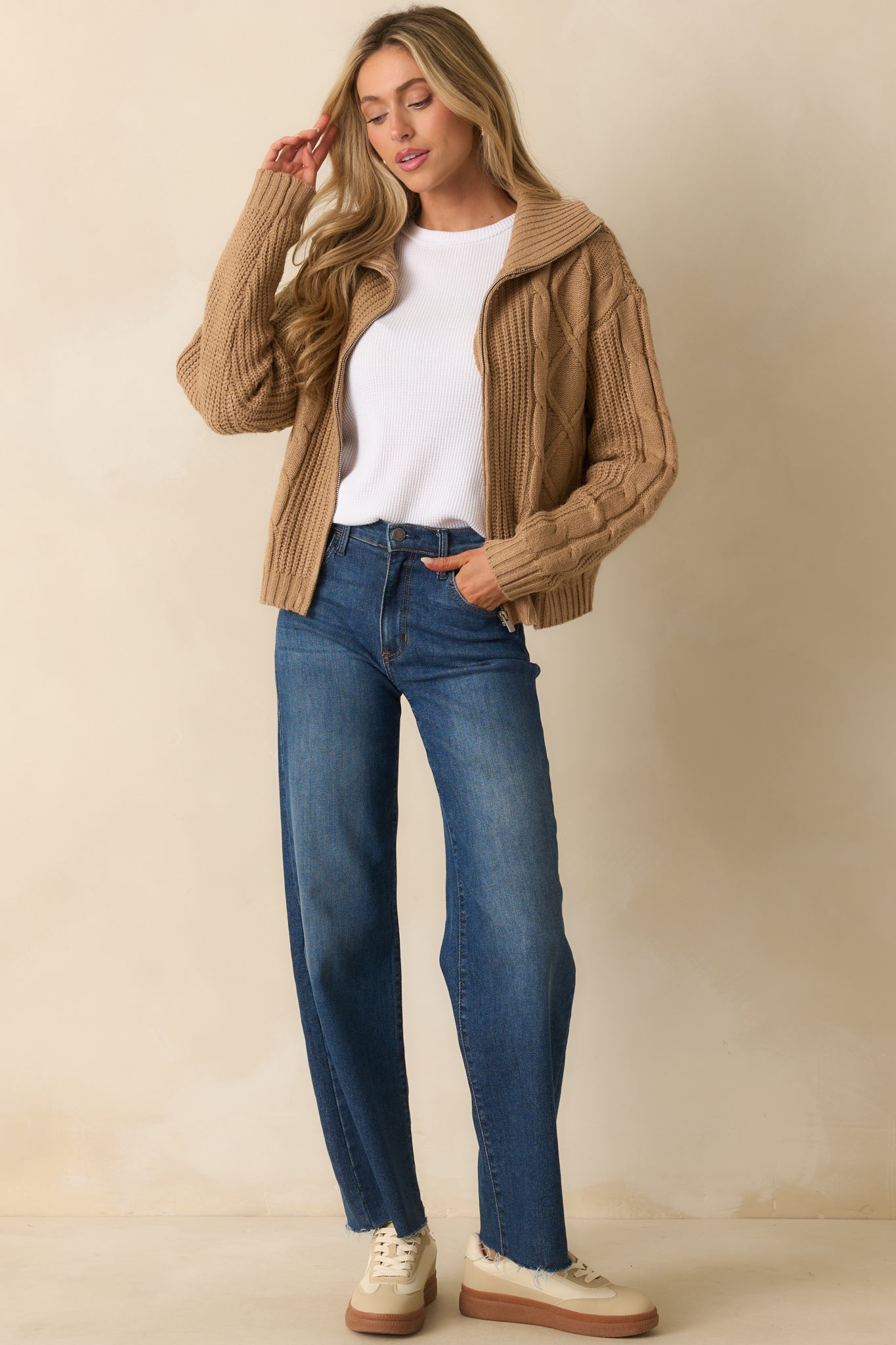 A full front-facing shot emphasizing its structured fit and textured cable knit pattern.