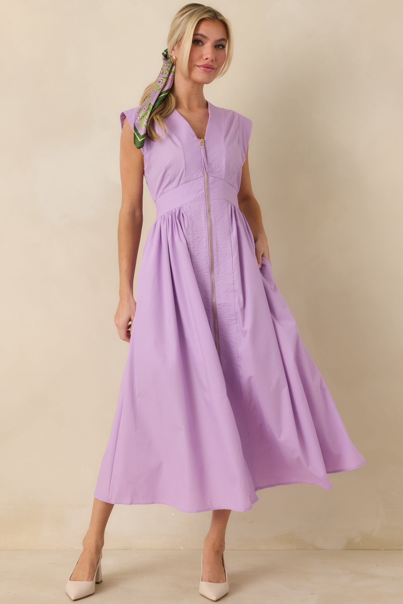 Front-facing full length shot highlighting the clean sleeveless design, centered zipper detail, and flowing midi-length skirt.