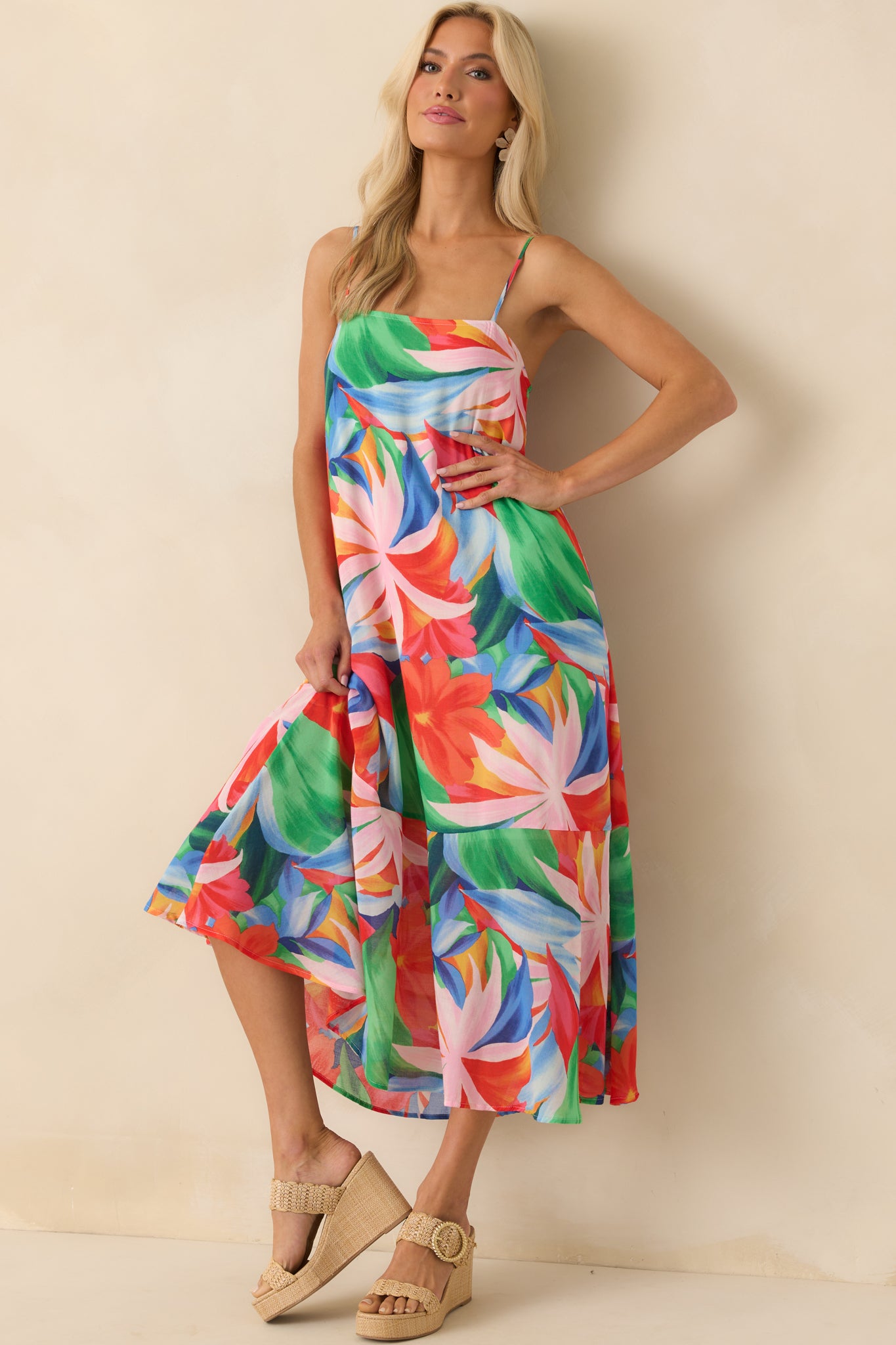 Full length side view capturing the silhouette of the relaxed fit and the way the crisscross back straps tie at the waist.