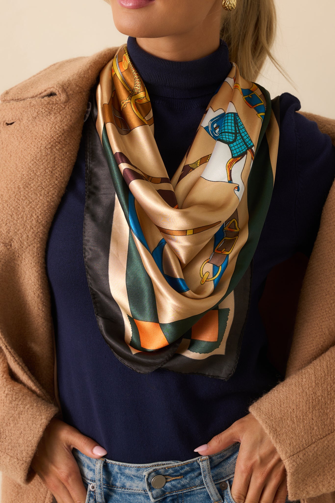 A full view of the gold square scarf showing the equestrian horse and carriage print and striped border.