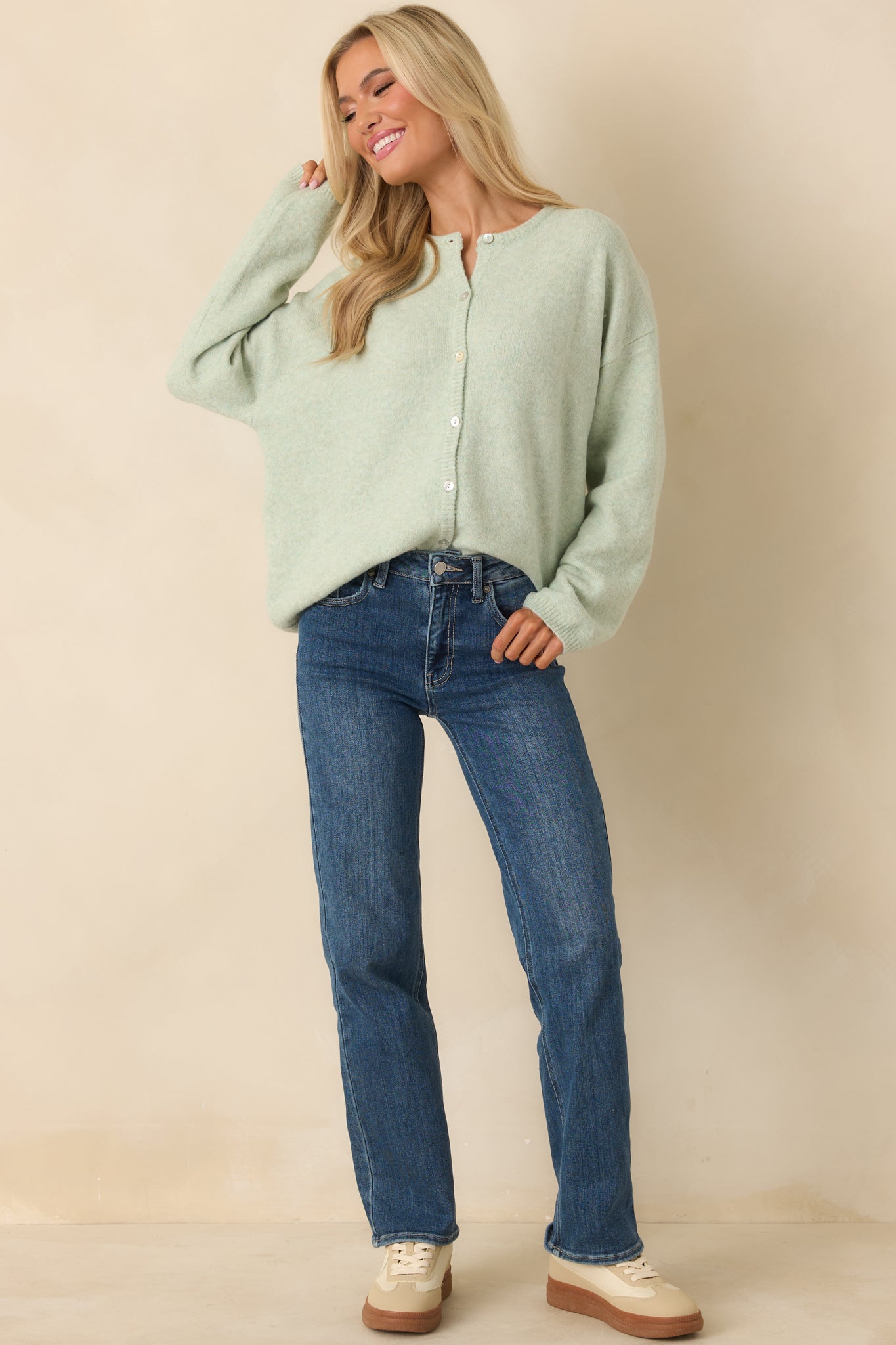 Full body view highlighting the long sleeves and soft knit fabrication of the mint green cardigan.