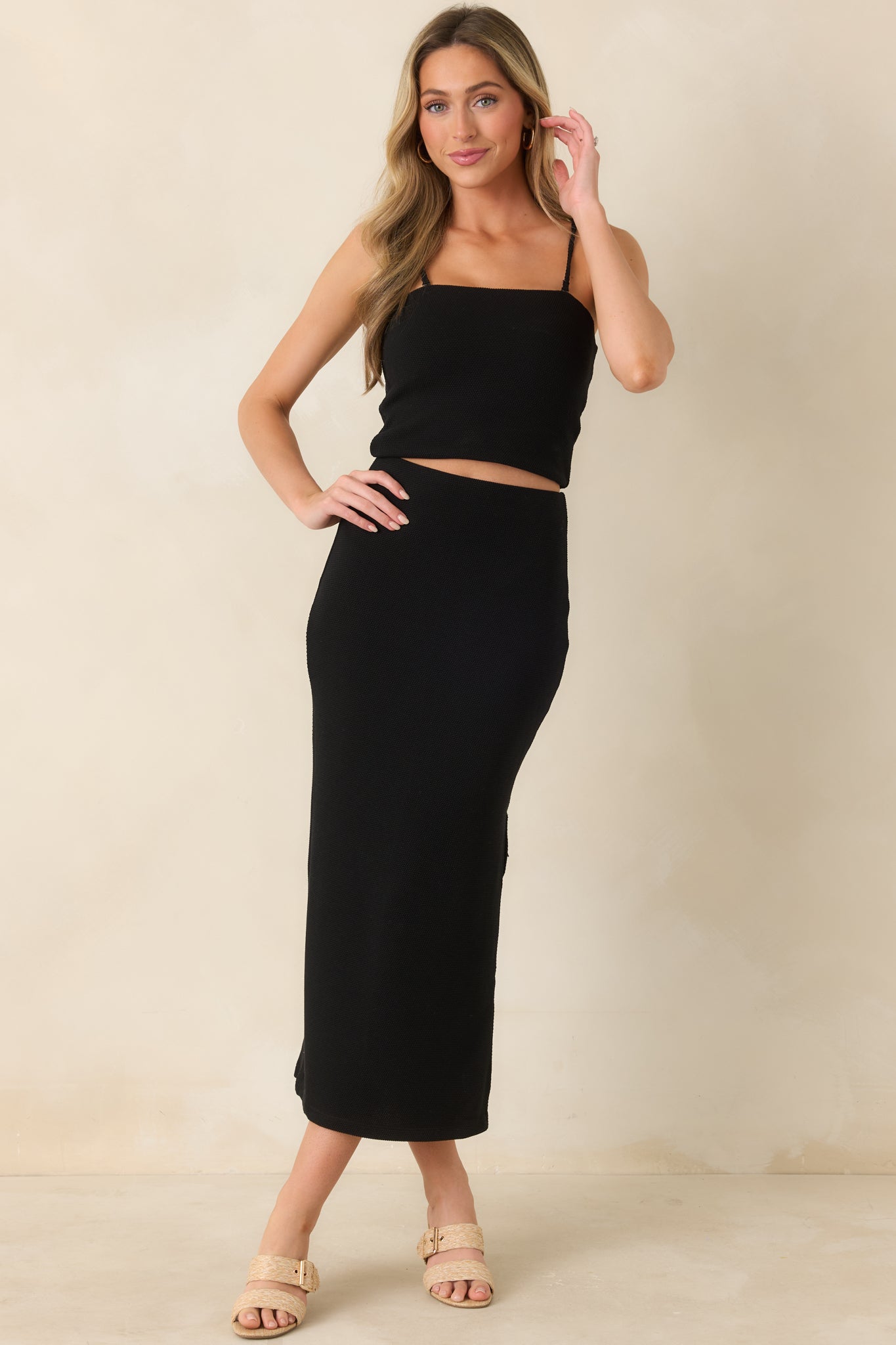 Full view of black tube top highlighting the snug silhouette and modern cropped cut.