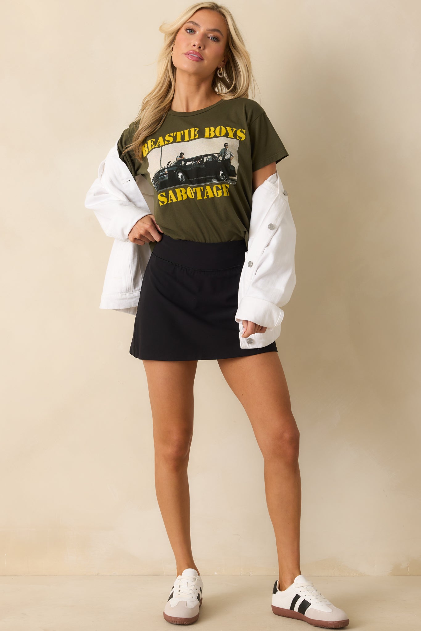 A full front view of the army green Beastie Boys tee featuring the bold band graphic and distressed yellow lettering.