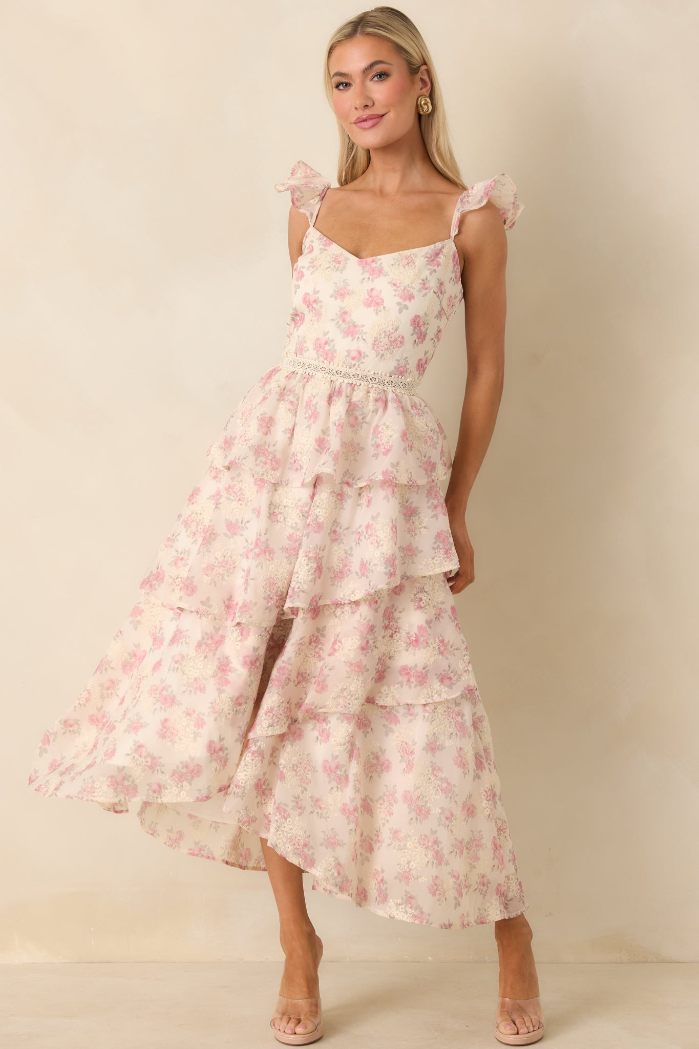 Front-facing full-length view of the beige dress showcasing the pink floral print and tiered skirt design.