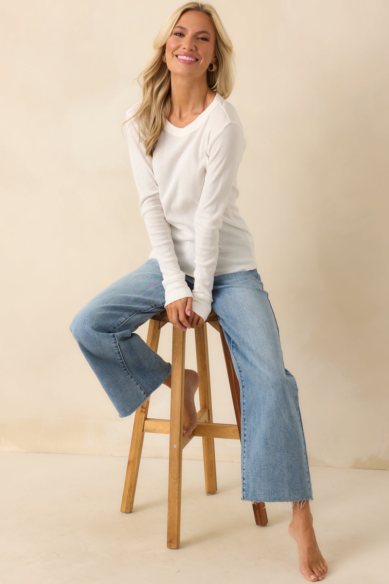 Full body front view of the ivory tee showing the crew neckline, long sleeves, and regular fit silhouette.