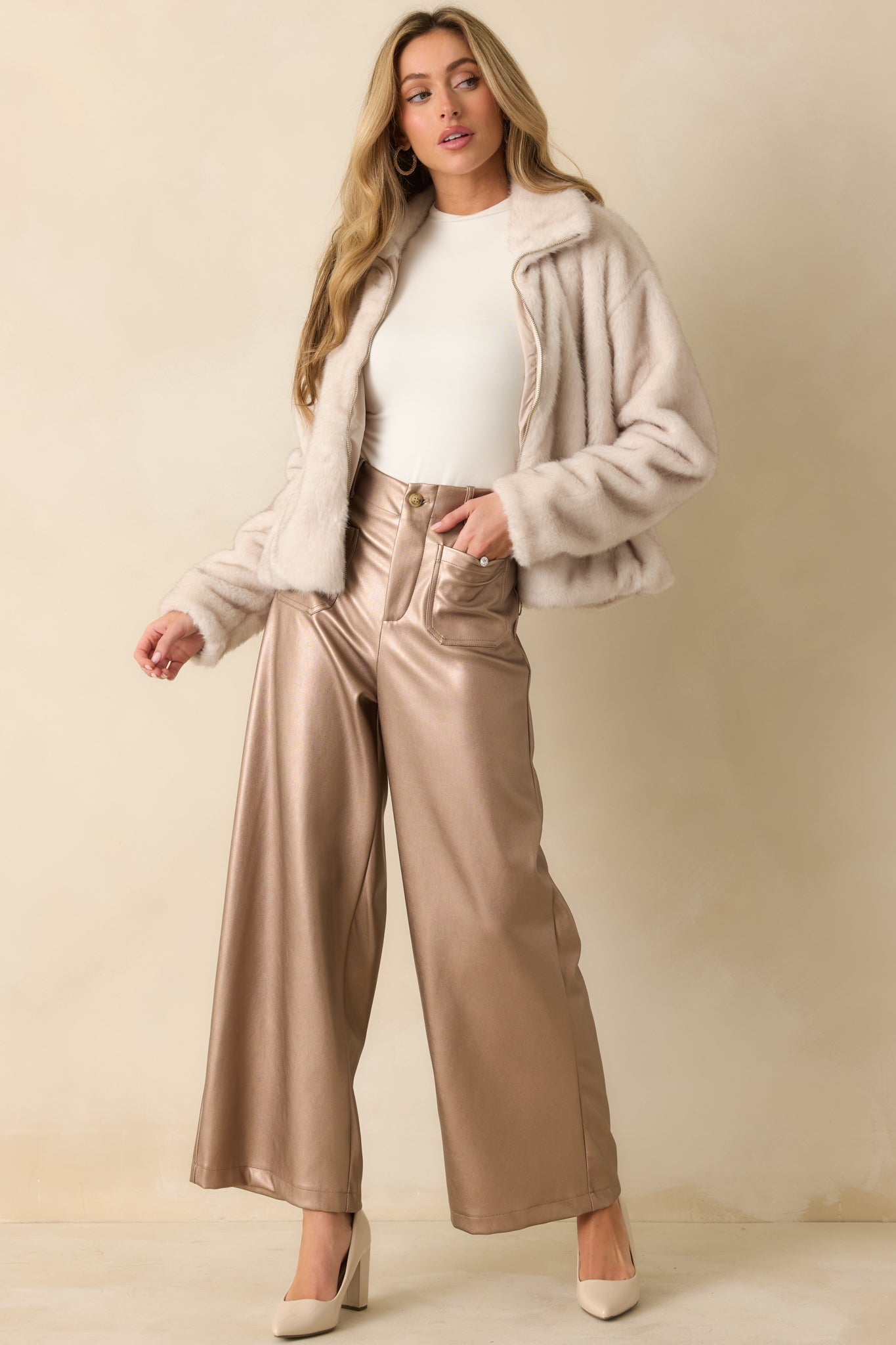 Full-length view of the ivory zip-up jacket showing the front zipper closure and overall cozy silhouette.