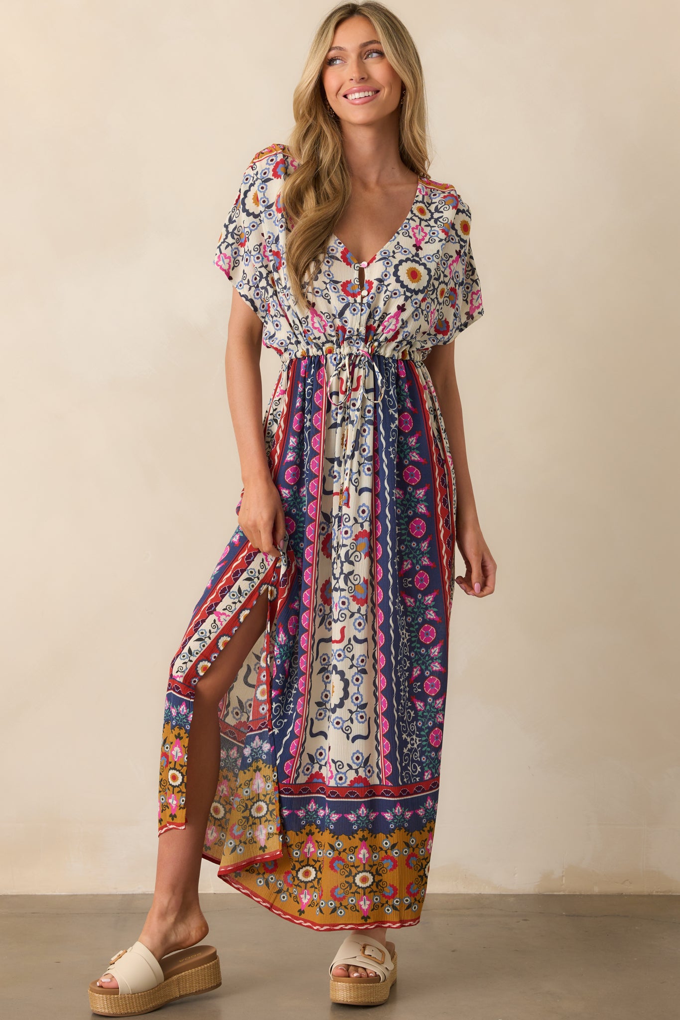 Front-facing full view of the navy maxi dress showcasing its multicolor patchwork print, V-neckline, and flowy silhouette.