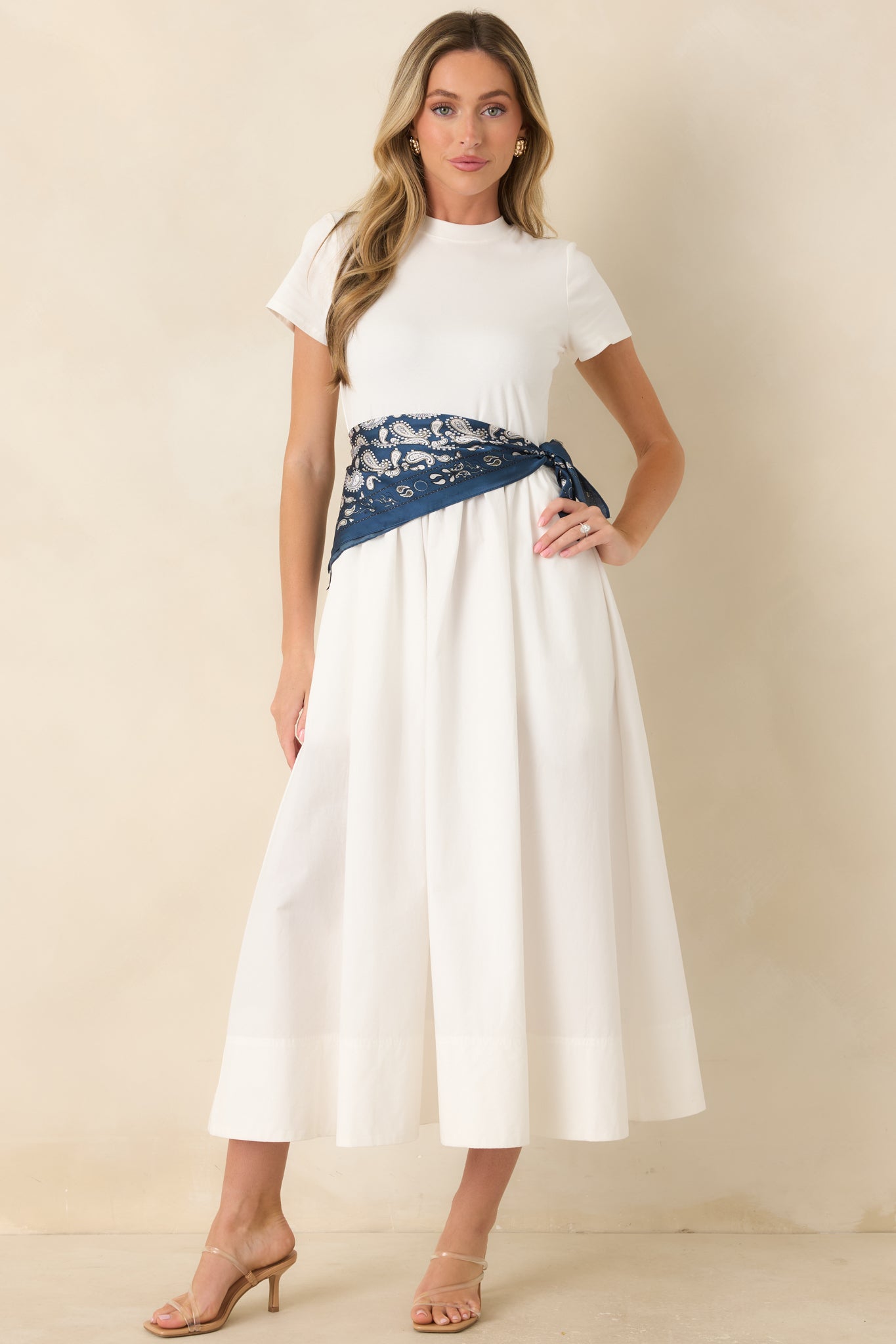 Full body view of white cotton midi dress features hidden side pockets, and a voluminous gathered midi skirt for a polished yet romantic finish.