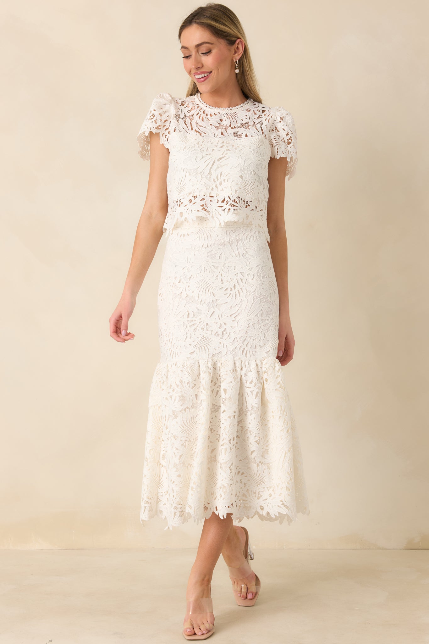 Full-length front view of the ivory midi skirt showcasing the floral lace overlay and scalloped hemline.