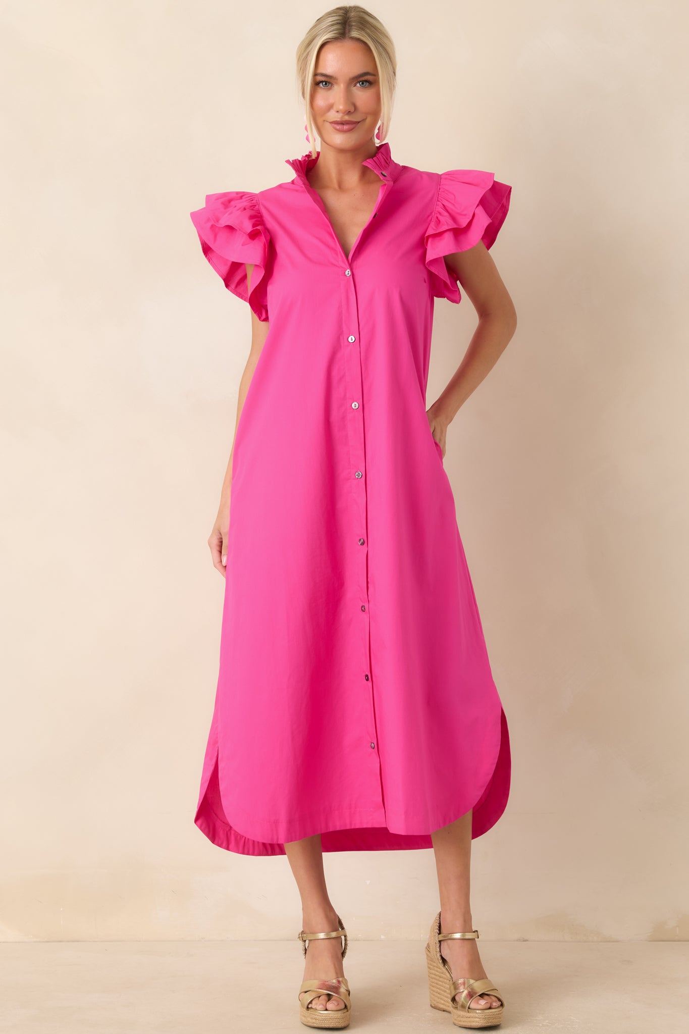Fully lined cotton midi dress with a vibrant design, button-front closure, and feminine ruffle accents.