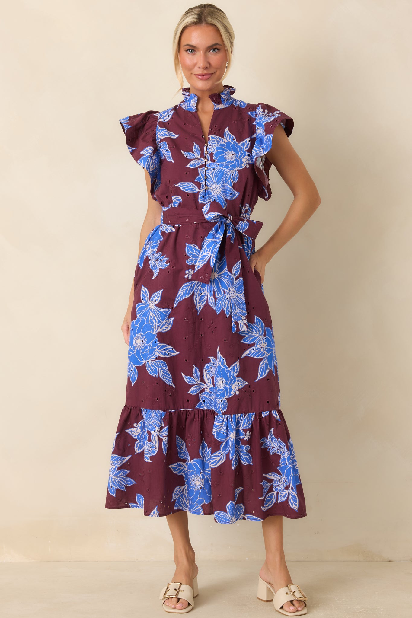 Fully lined dress designed with a removable self-tie belt, flutter sleeves, and side pockets for a polished yet practical look.