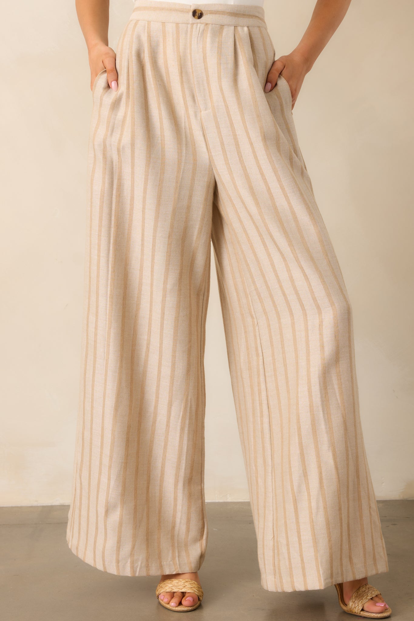 The functional pockets of the beige pants, offering both style and practicality for everyday wear.