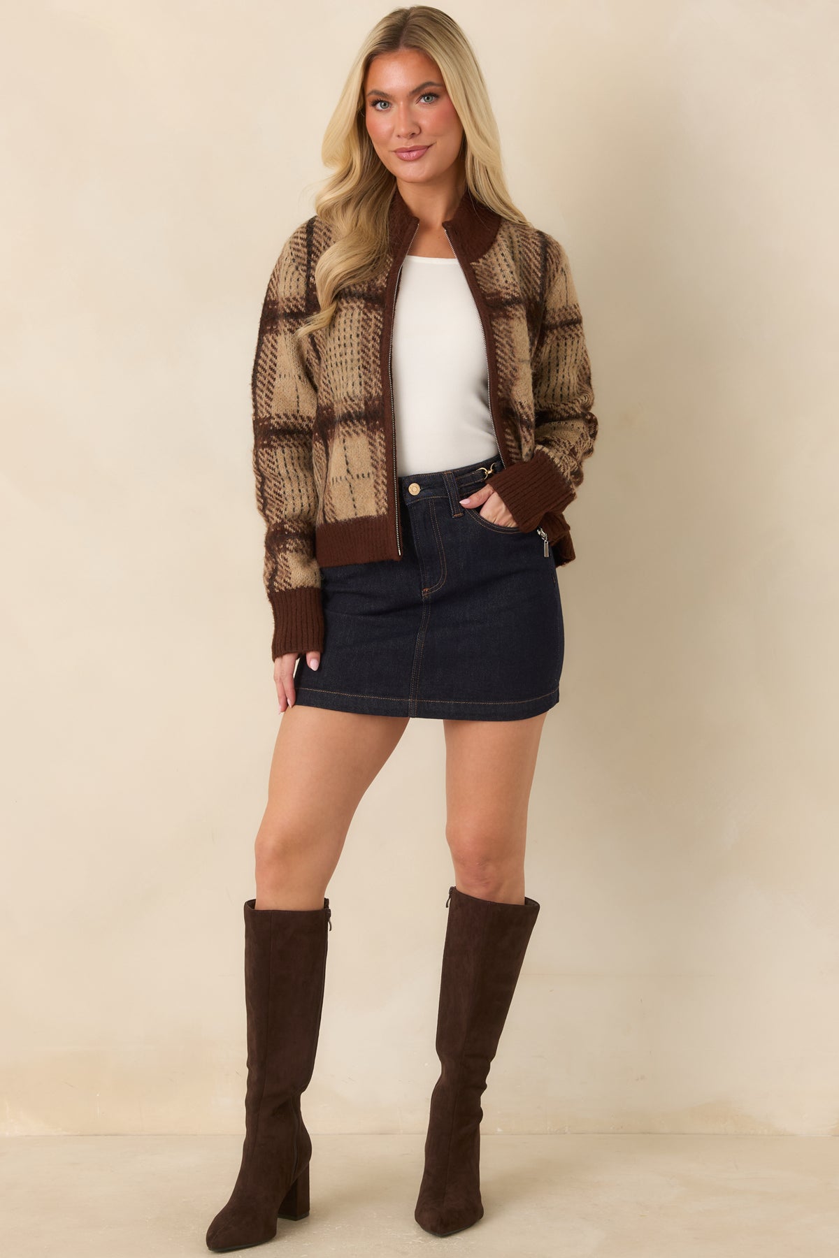 Fuzzy plaid cardigan featuring dark line detailing, long sleeves, and deep brown ribbed cuffs and hem.