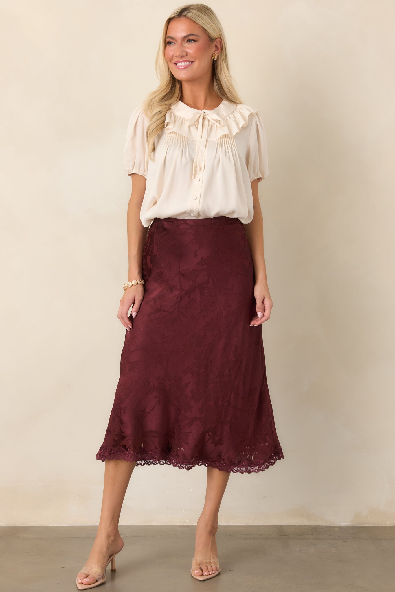 Lightweight champagne blouse with a softly gathered shape, short puff sleeves, elastic cuffs, and an elegant cropped silhouette.