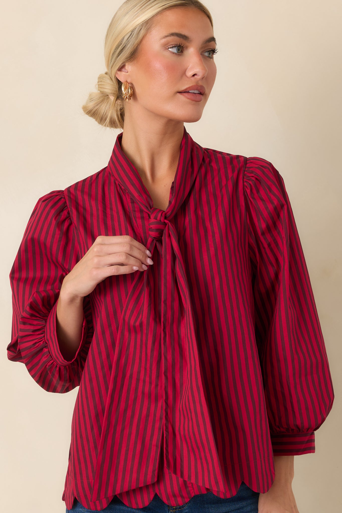 Detailed view highlighting the softly gathered shoulders, bold stripe pattern, and lightweight cotton texture.