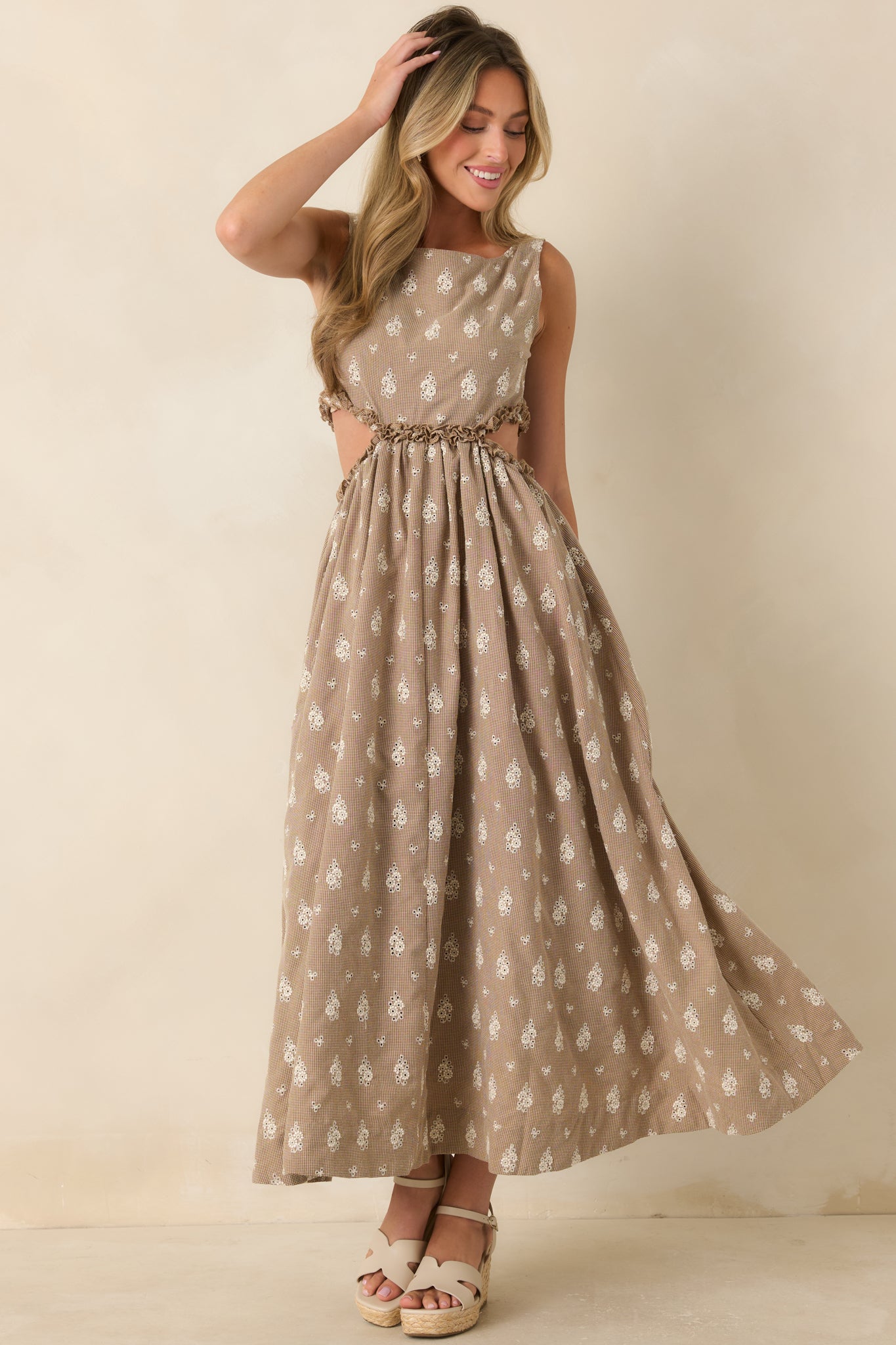 Front-facing view emphasizing the gathered waist, airy silhouette, and ruffle-trimmed side cut-outs on the floral eyelet maxi dress.
