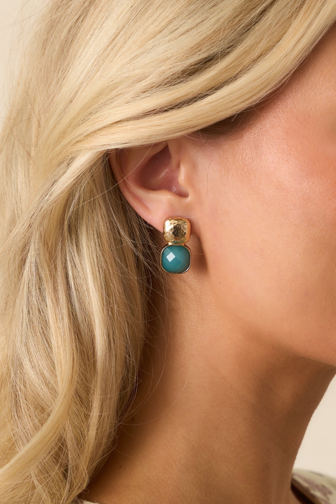 Geometric gold-and-green earrings with a modern square design.