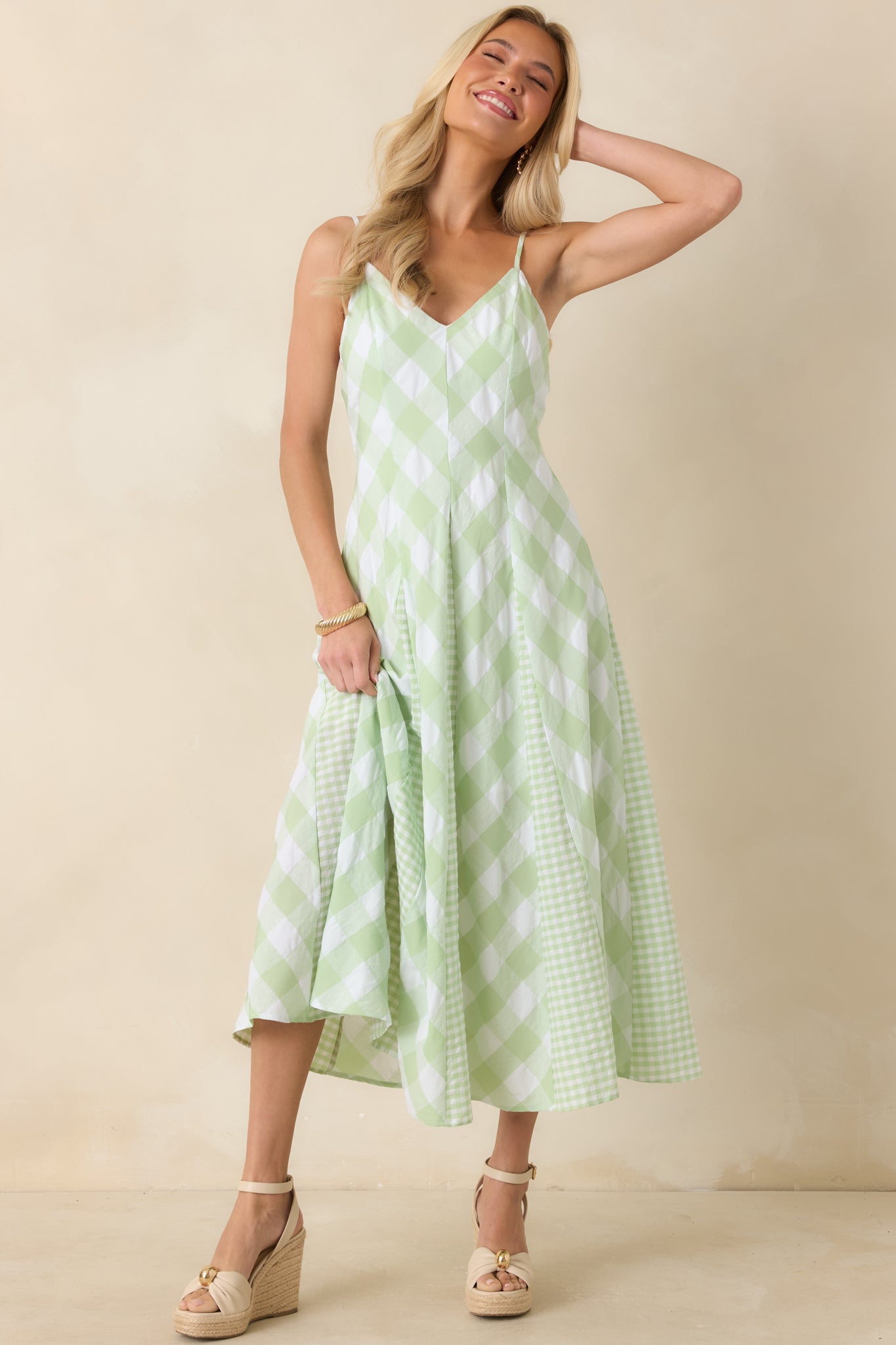 A-line gingham dress designed with a structured bodice, adjustable straps, and graceful movement.