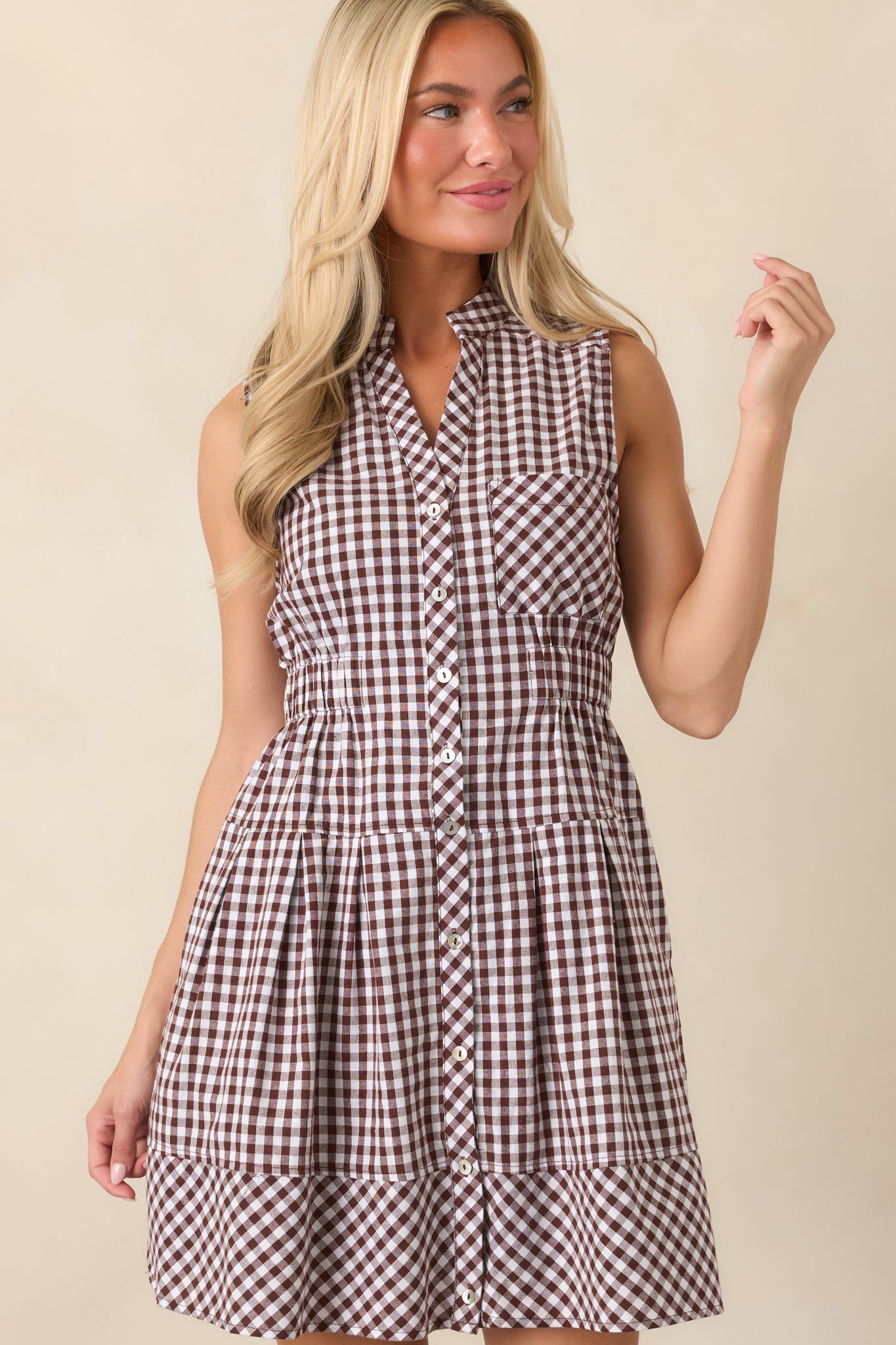 Detailed view of the gingham dress highlighting the short sleeve, smooth lined construction, and relaxed skirt shape.
