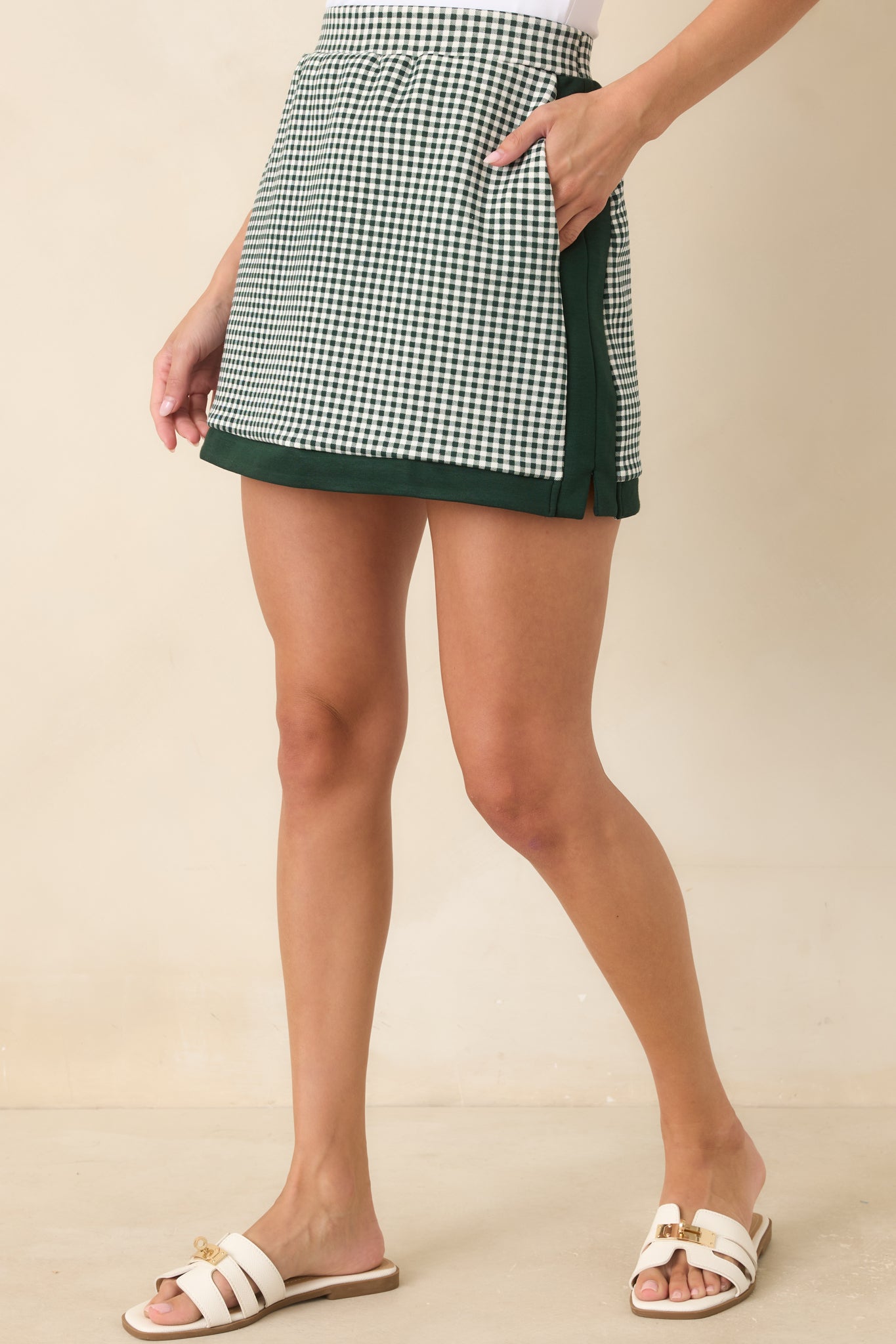 The front of this gingham skirt highlights the clean waistband and contrasting trim details.